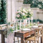 garden wedding reception with elegant florals on wooden table at Swan House Atlanta