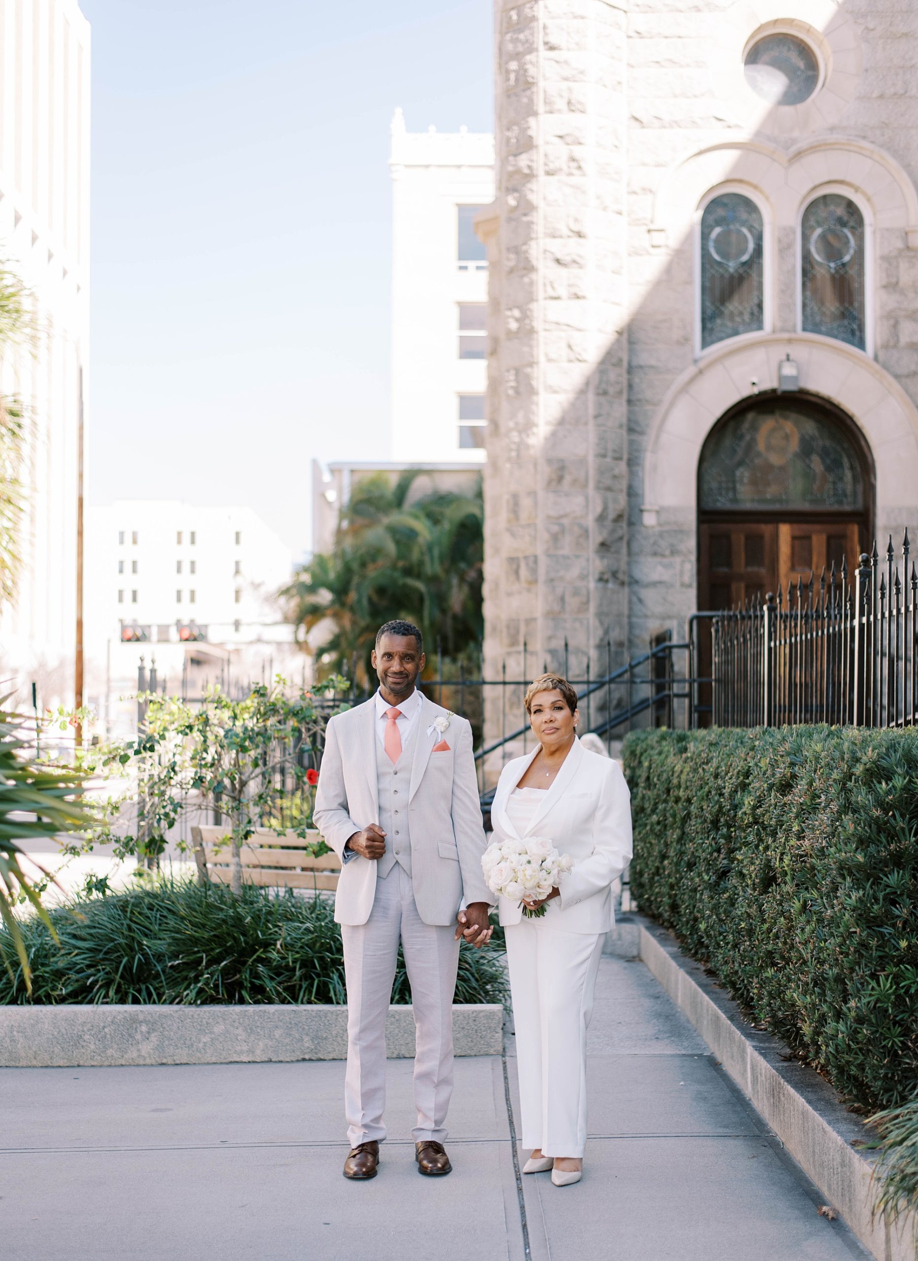 bride and groom pose outside courthouse at Downtown Tampa wedding