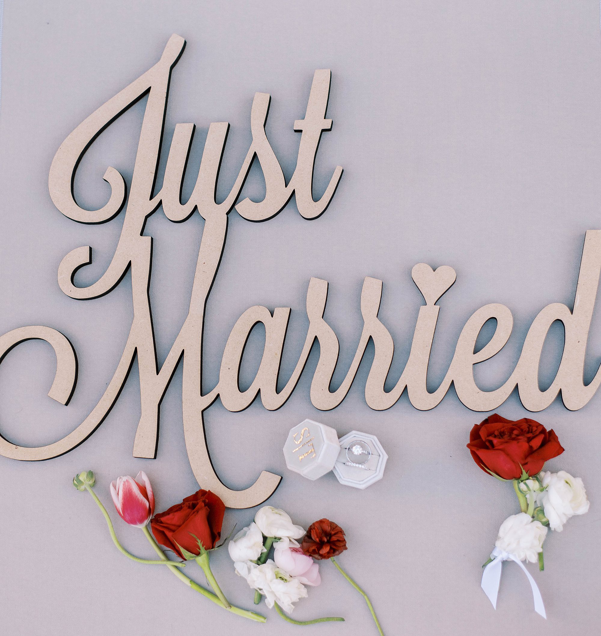 just married sign with red and white flowers
