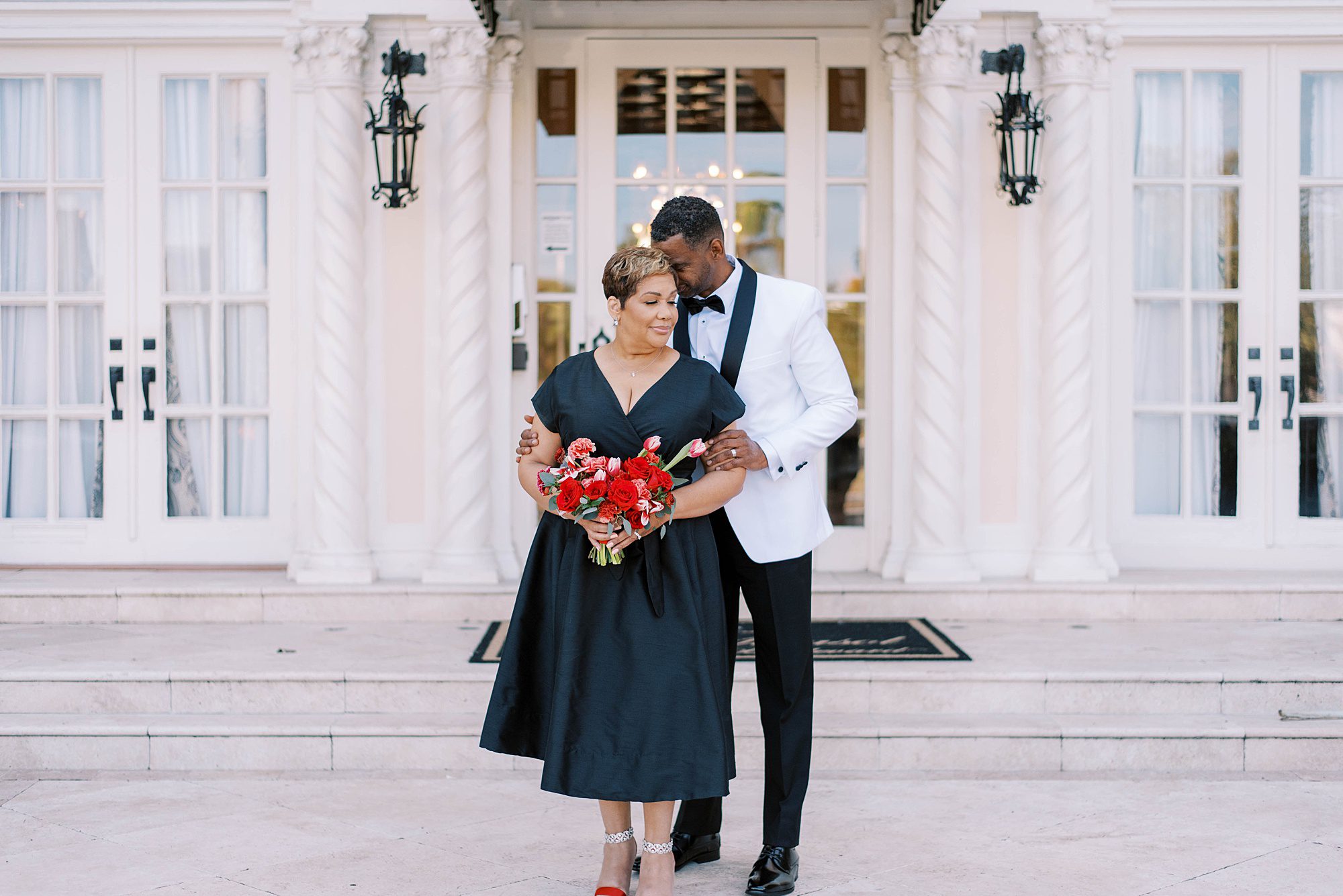 bride and groom pose on steps of Le Meridien Hotel in Tampa FL