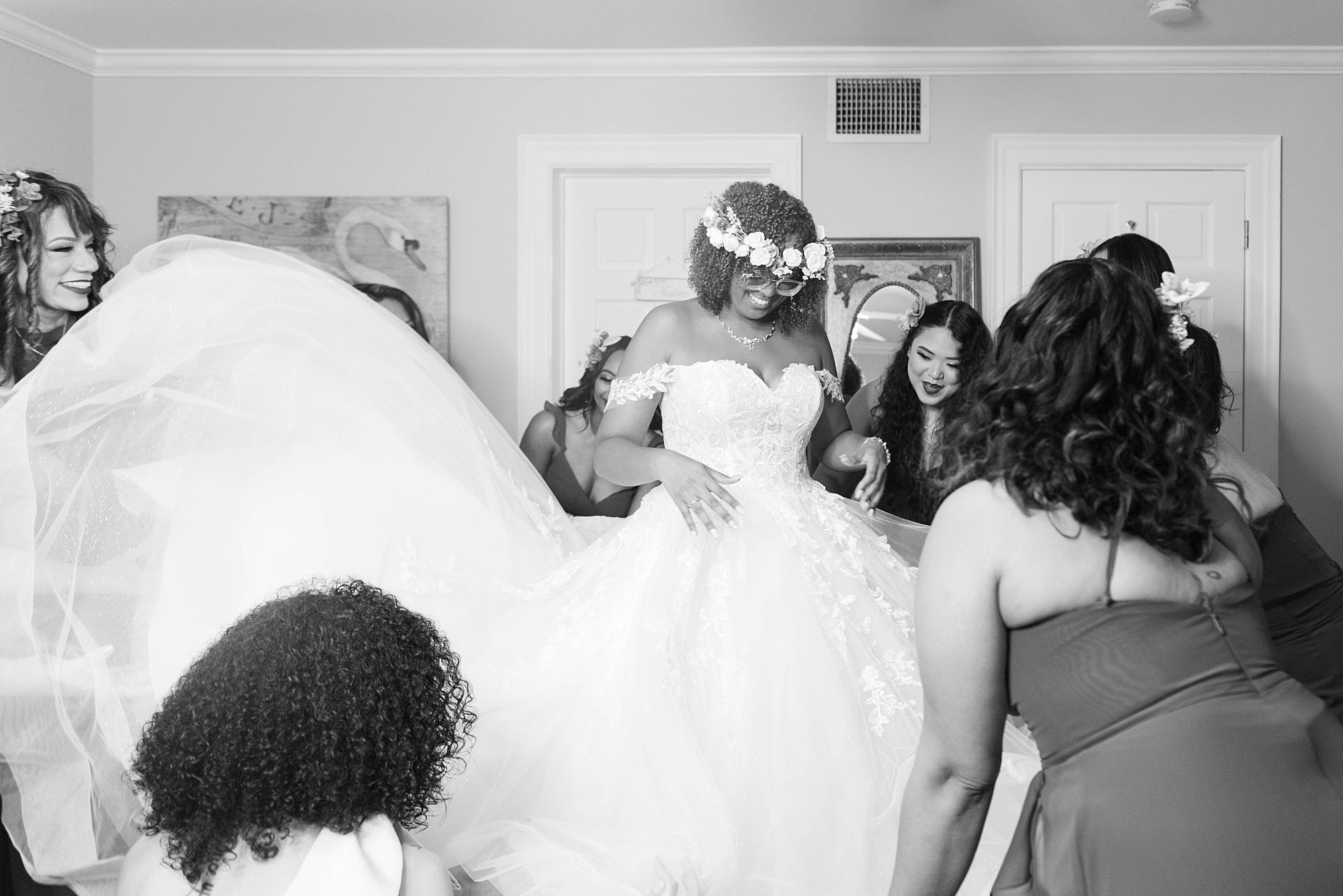 bridesmaids help bride into wedding gown before FL wedding