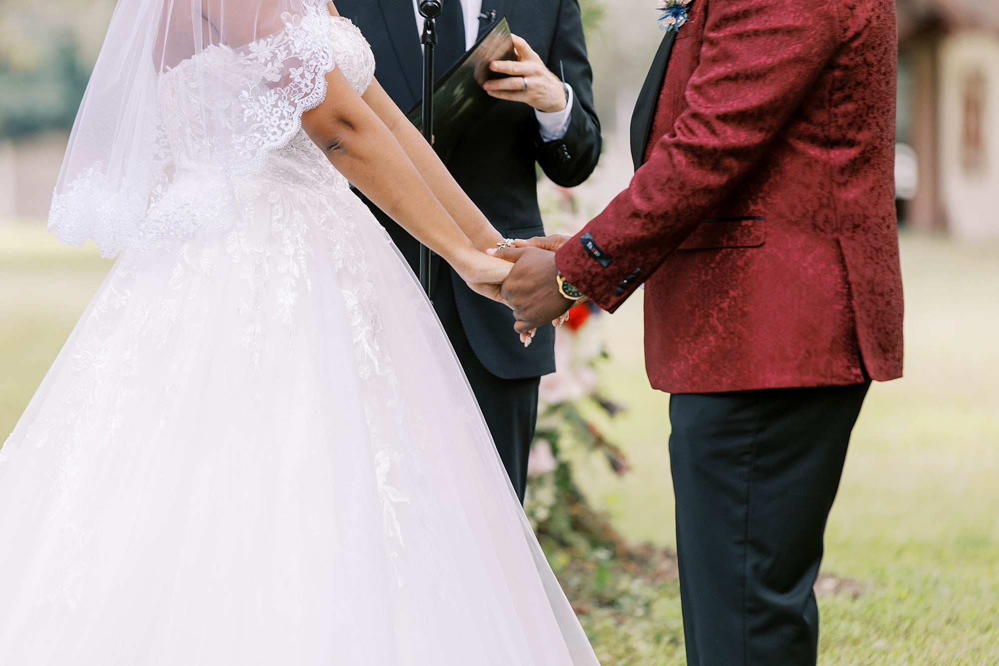 bride and groom hold hands during outdoor ceremony at Casa Lantana