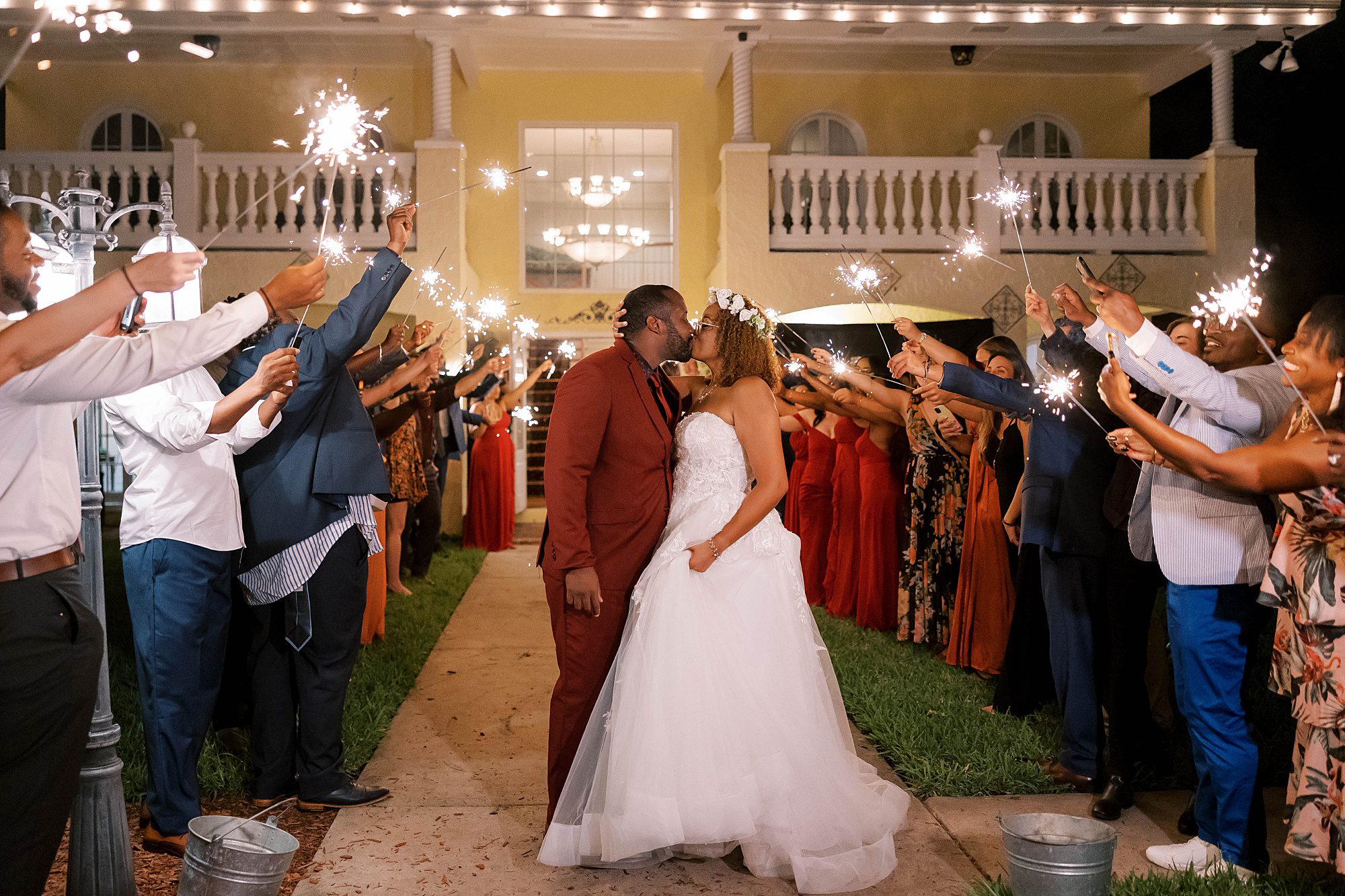 bride and groom kiss during sparkler exit at Casa Lantana