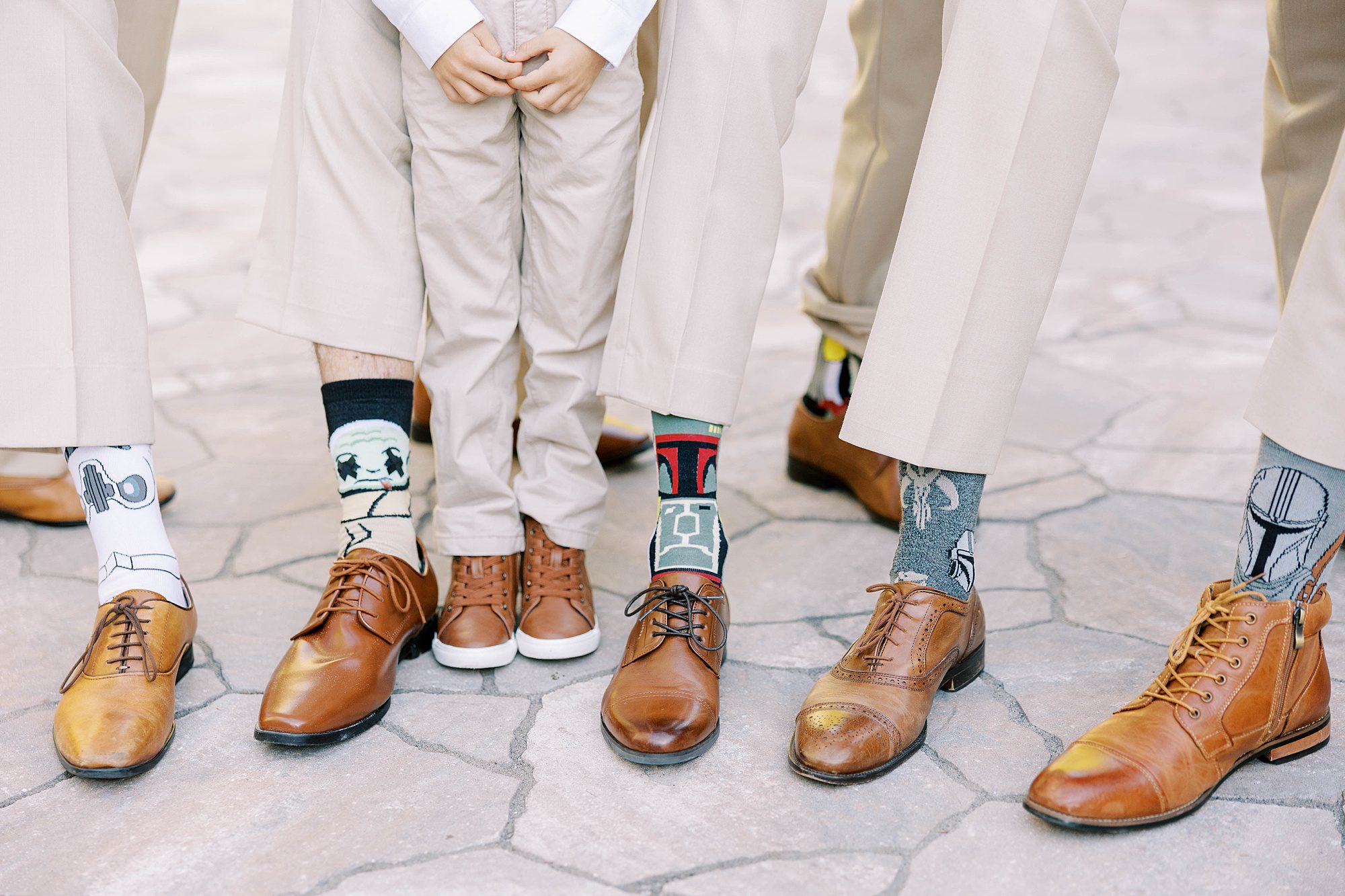 groom and groomsmen show off silly socks during FL wedding photos