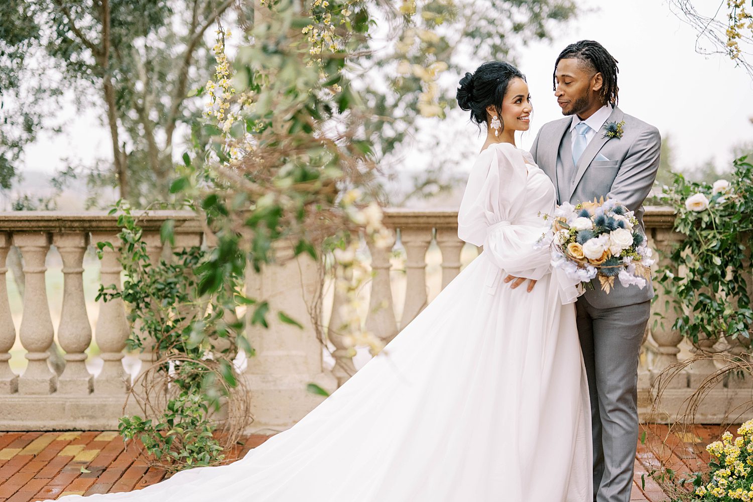 couple poses on balcony during Bella Collina styled shoot