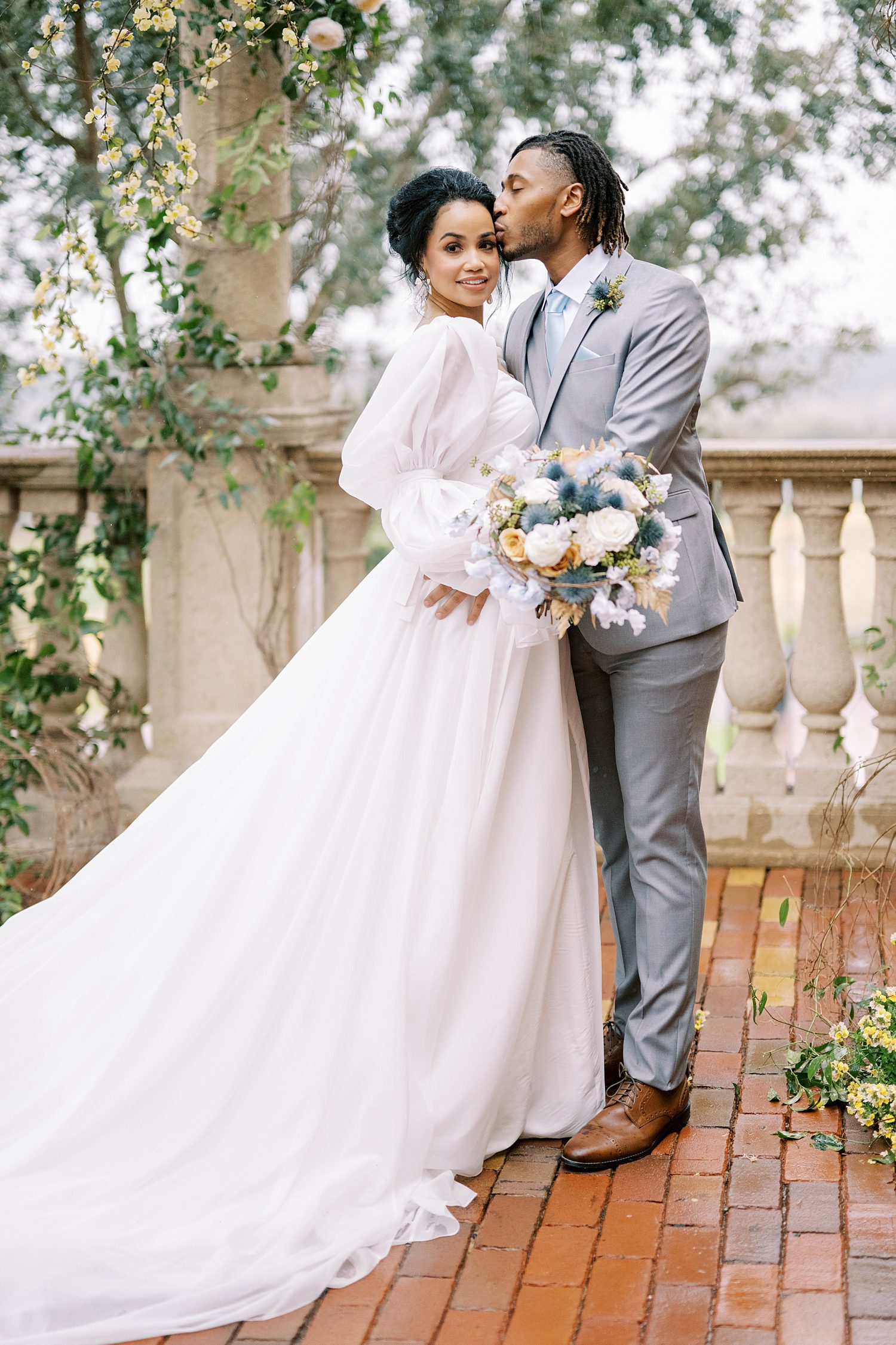 couple stands on patio during styled shoot inspired by Italian countryside