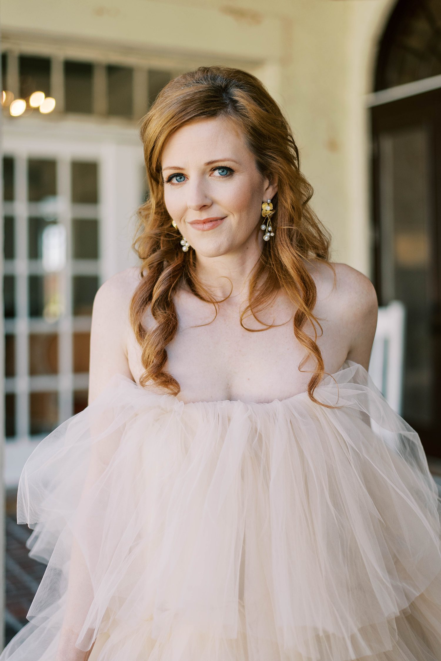 bride smiles in strapless champagne gown with layers of tulle