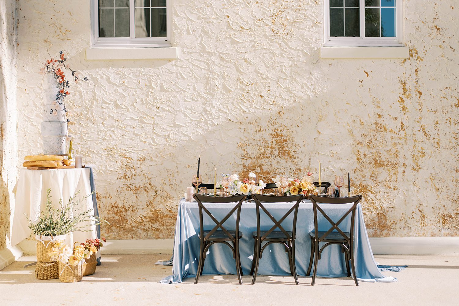 intimate wedding reception at wooden table with blue table cloth