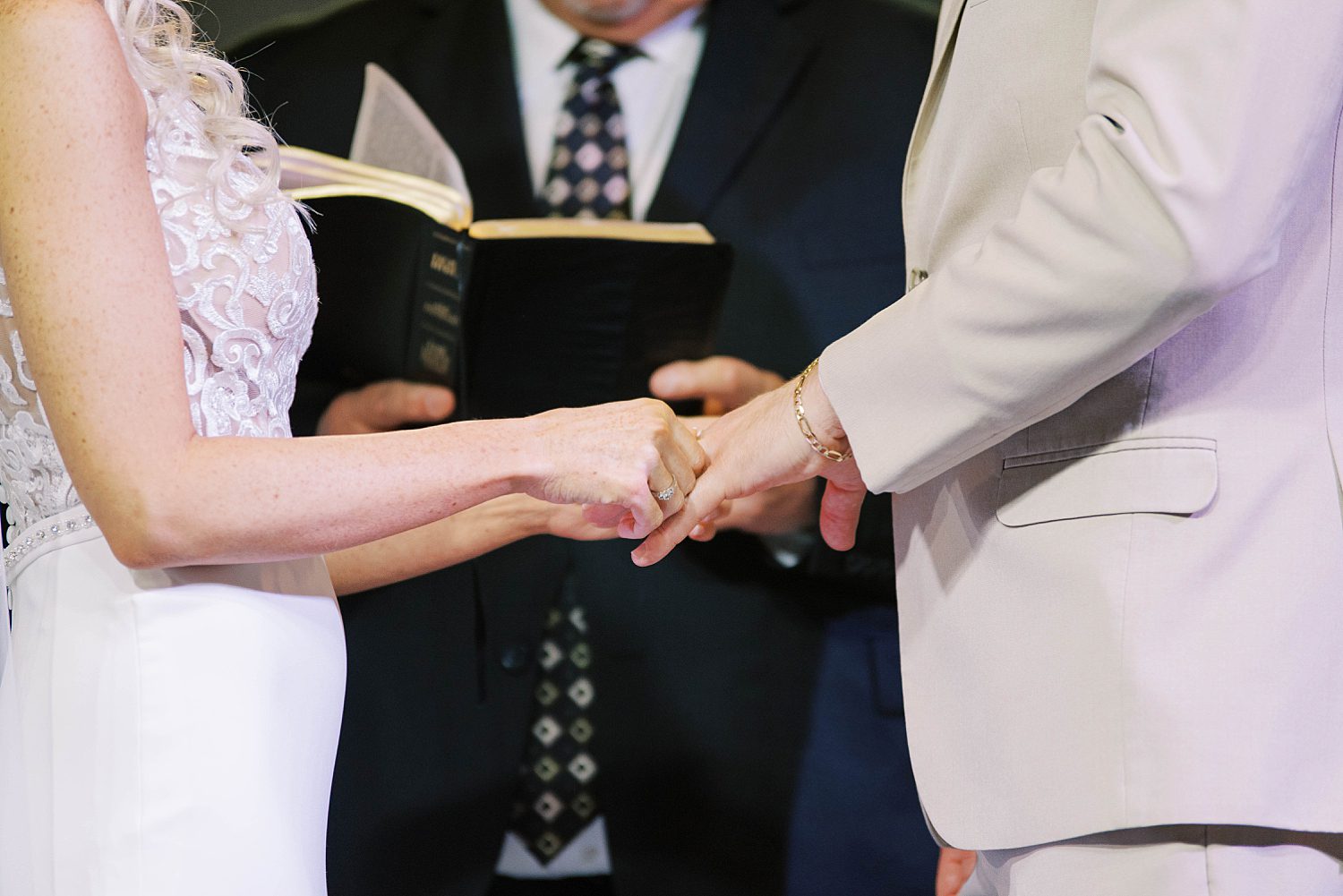 newlyweds hold hands during FL wedding ceremony