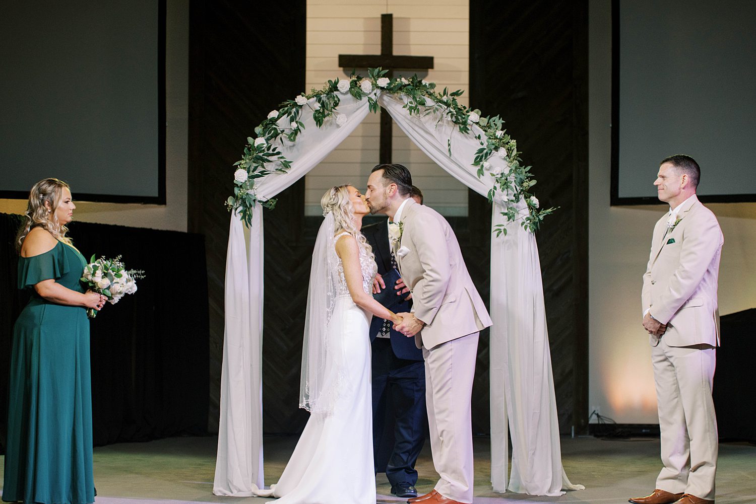 bride and groom kiss during wedding ceremony in Florida