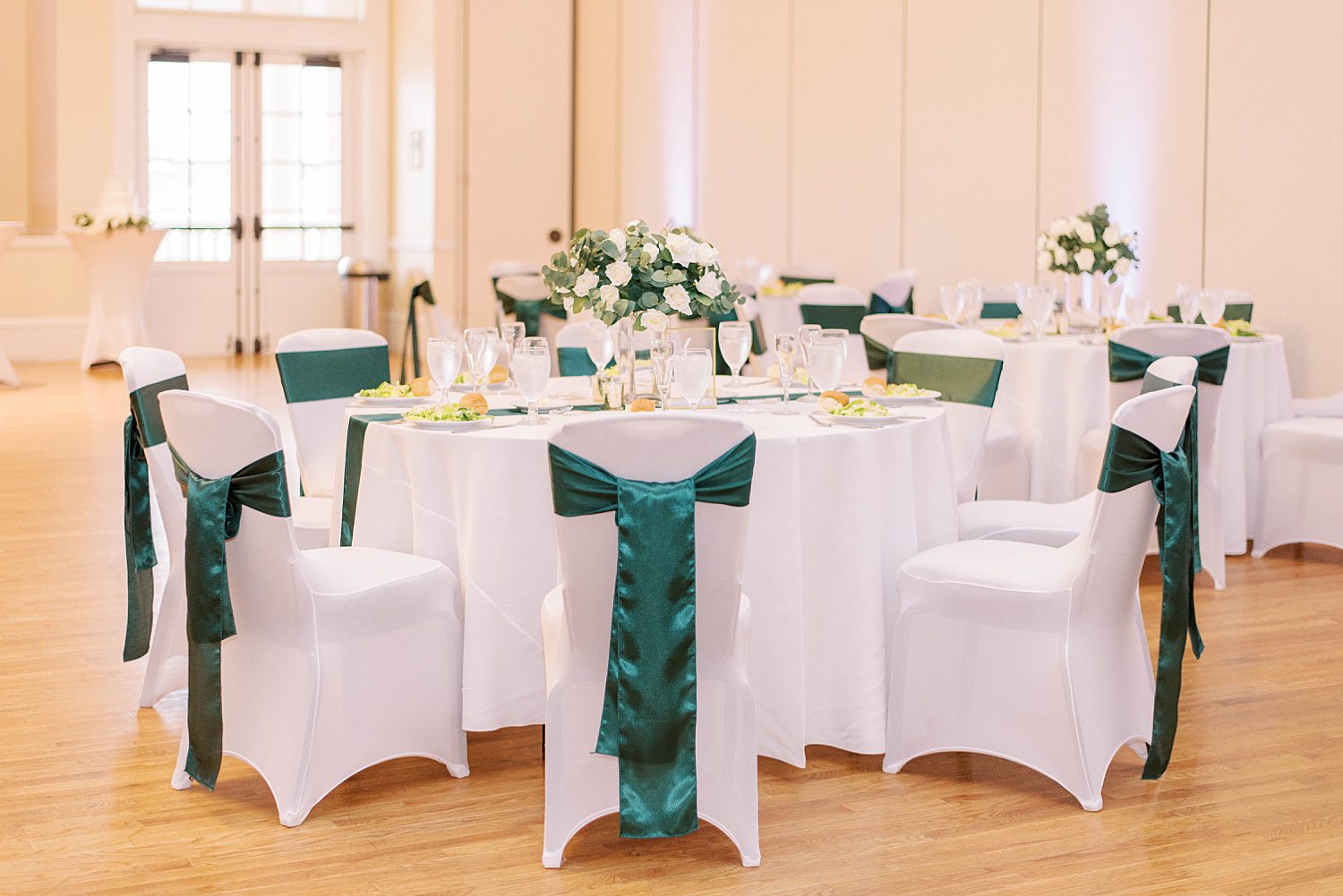 wedding ceremony at The Regent with emerald and ivory color palette