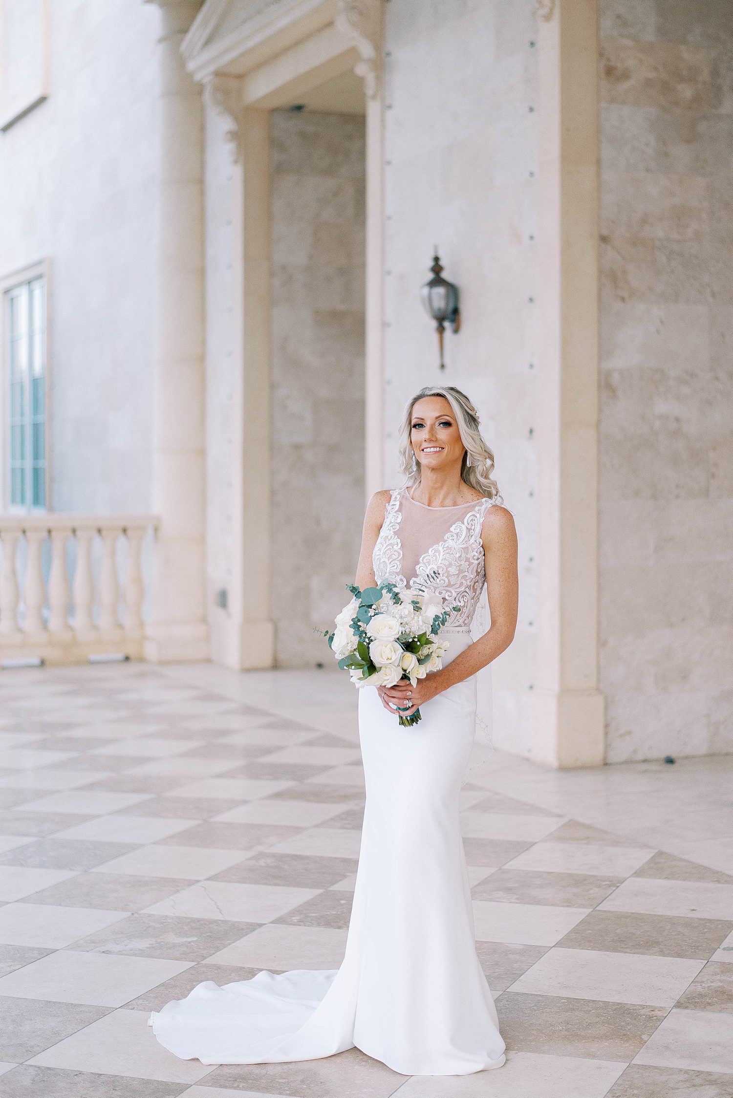 bride stands in wedding dress with lace details on The Regent