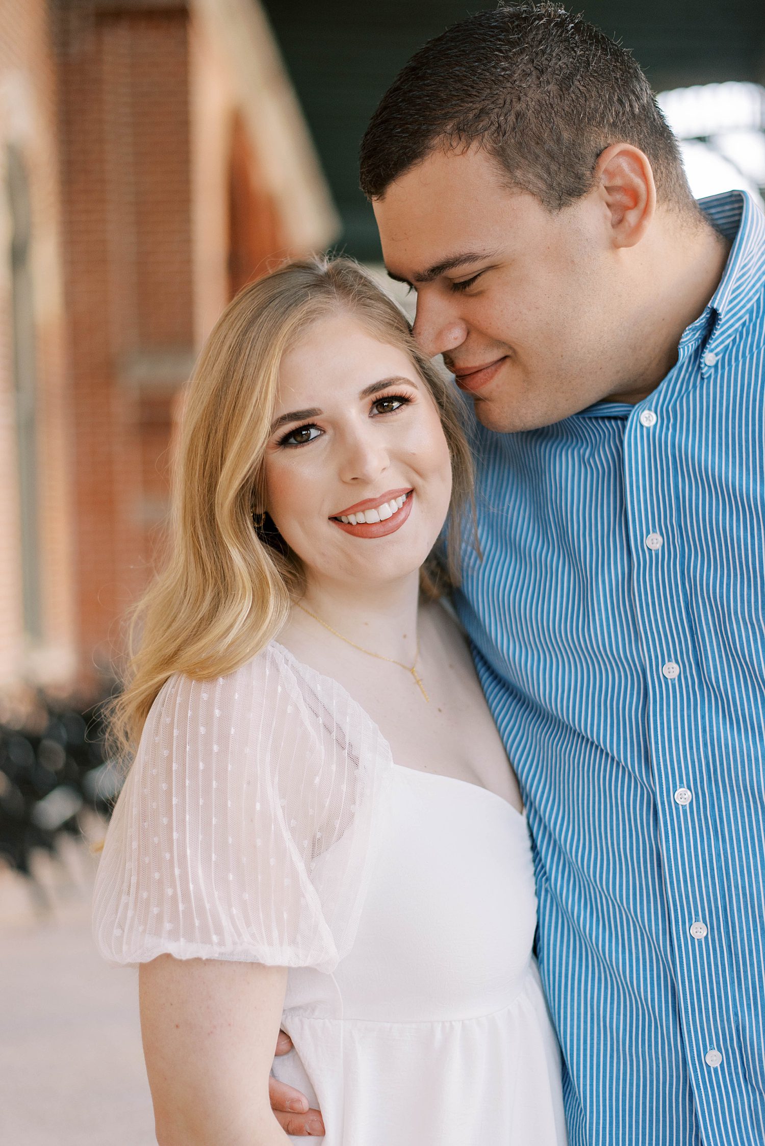 groom nuzzles bride's cheek at the University of Tampa in Florida during engagement photos