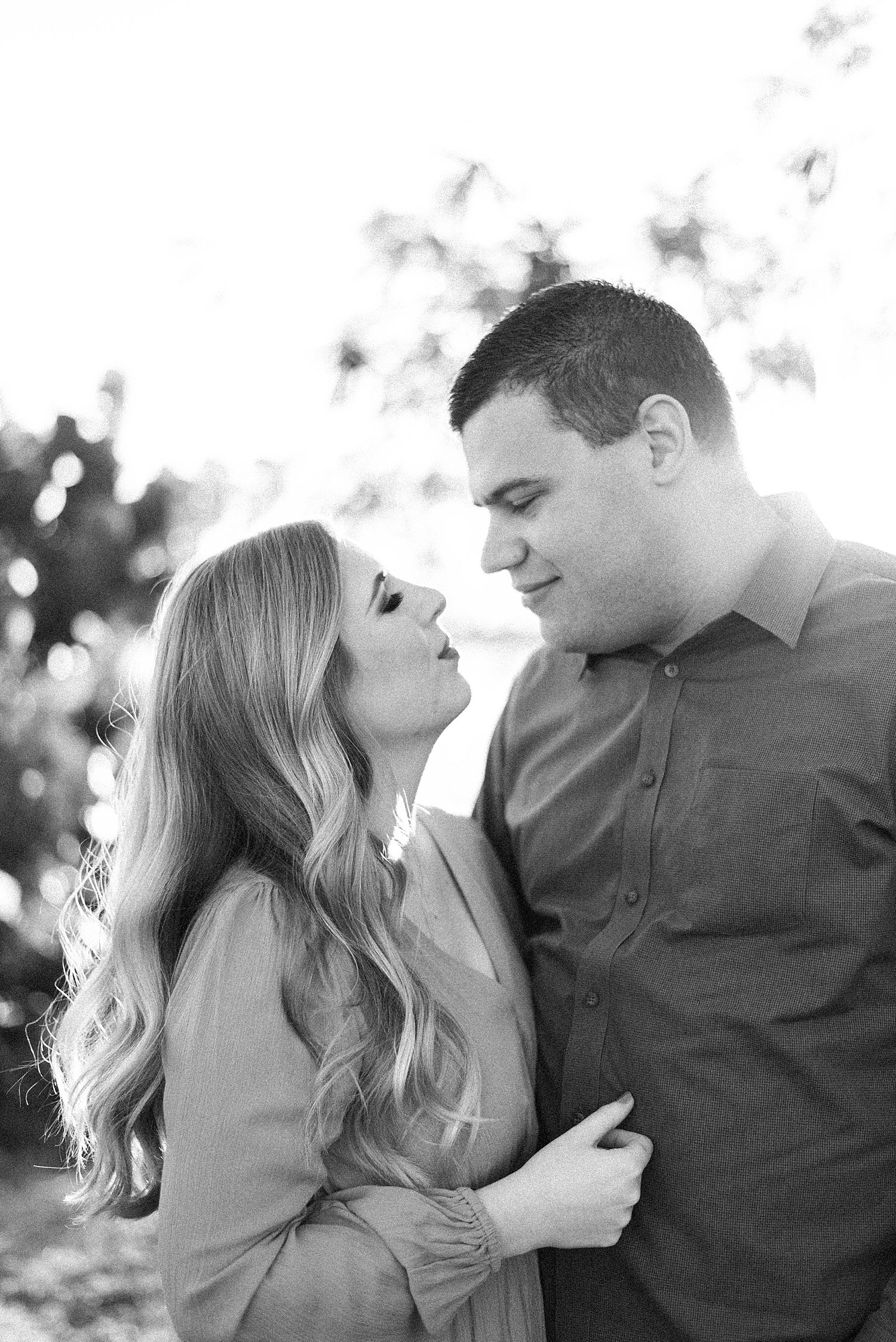 bride and groom hug at sunset during FL engagement session 