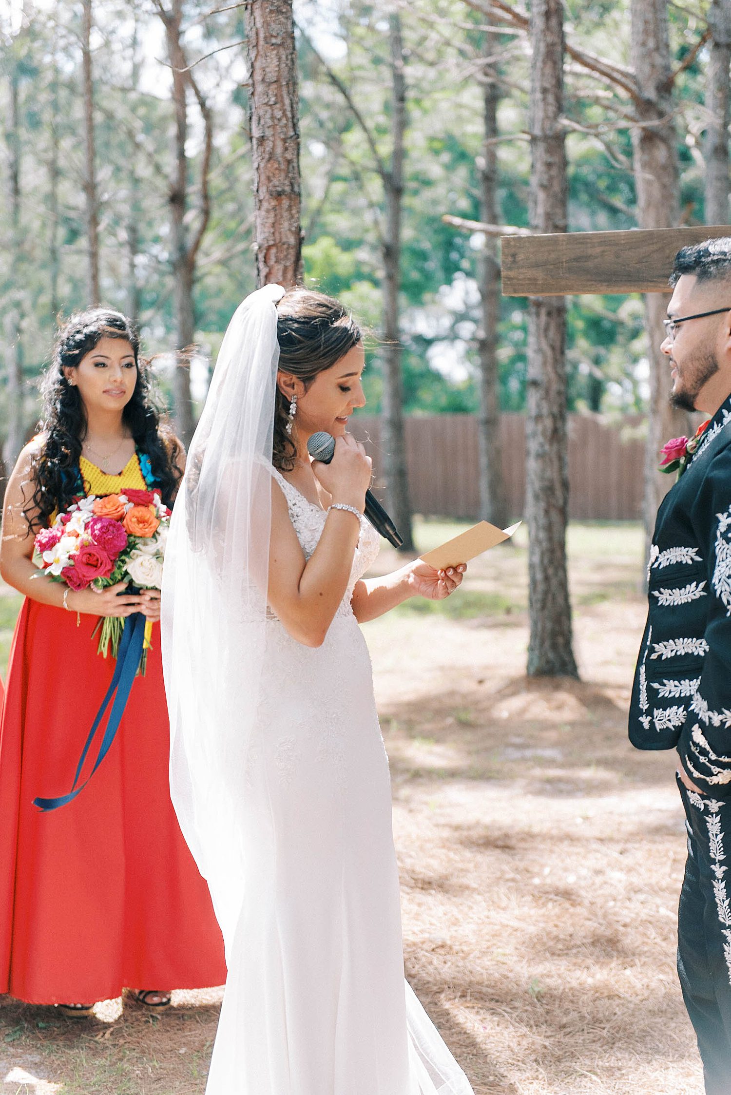 bride reads vows during wedding ceremony at The Barn at Lone Oak Acres