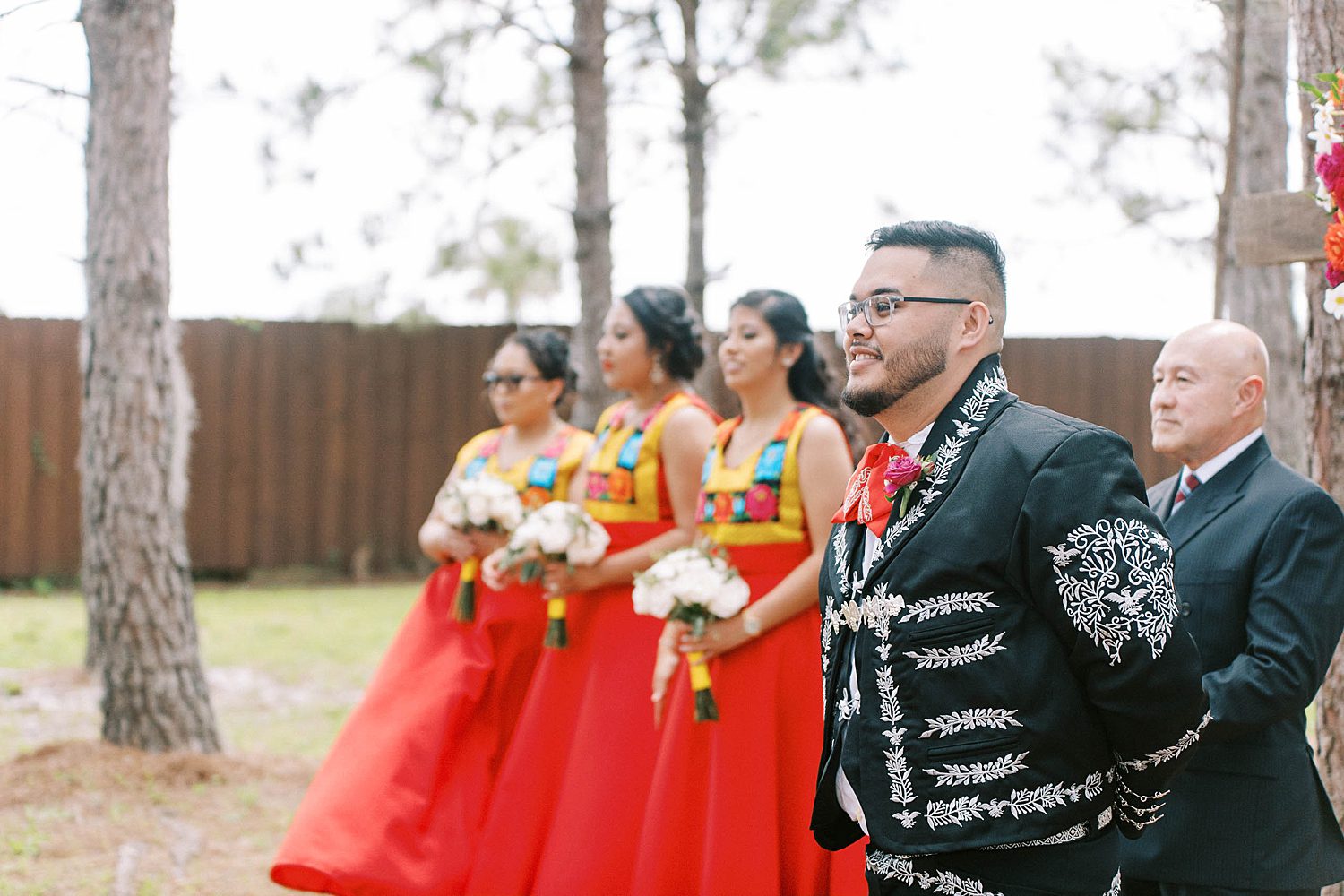 groom and bridesmaids watch bride walk down aisle for ceremony
