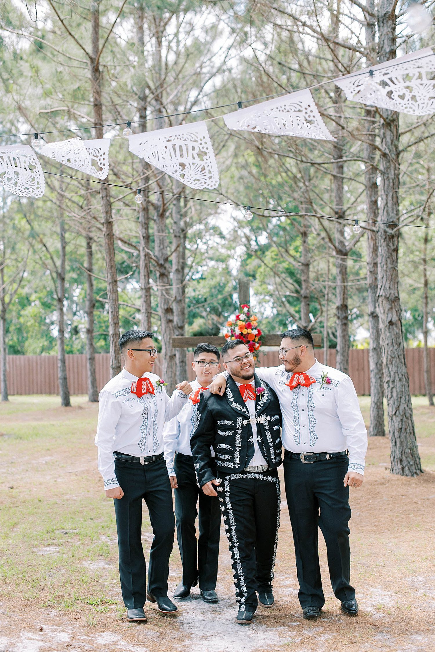 groomsmen hug groom during Mexican inspired wedding photos