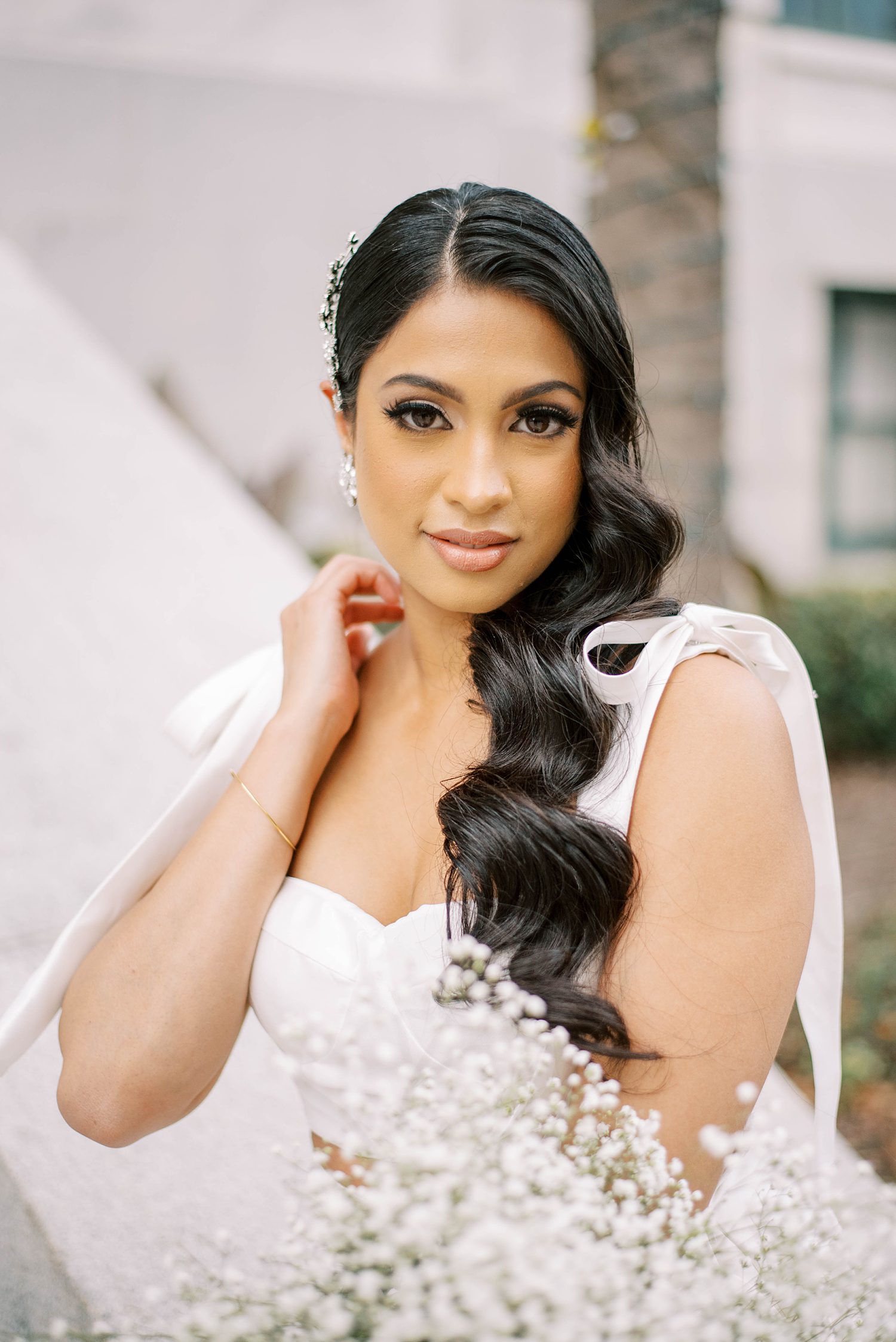 bride moves hair around shoulder during bridal portraits at Tampa Courthouse