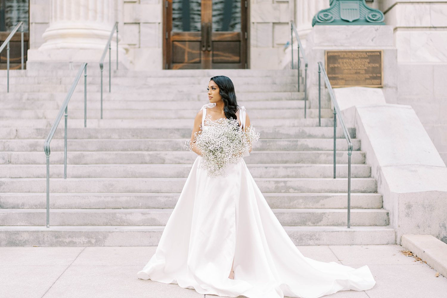 bride poses in Downtown Tampa FL in modern wedding gown