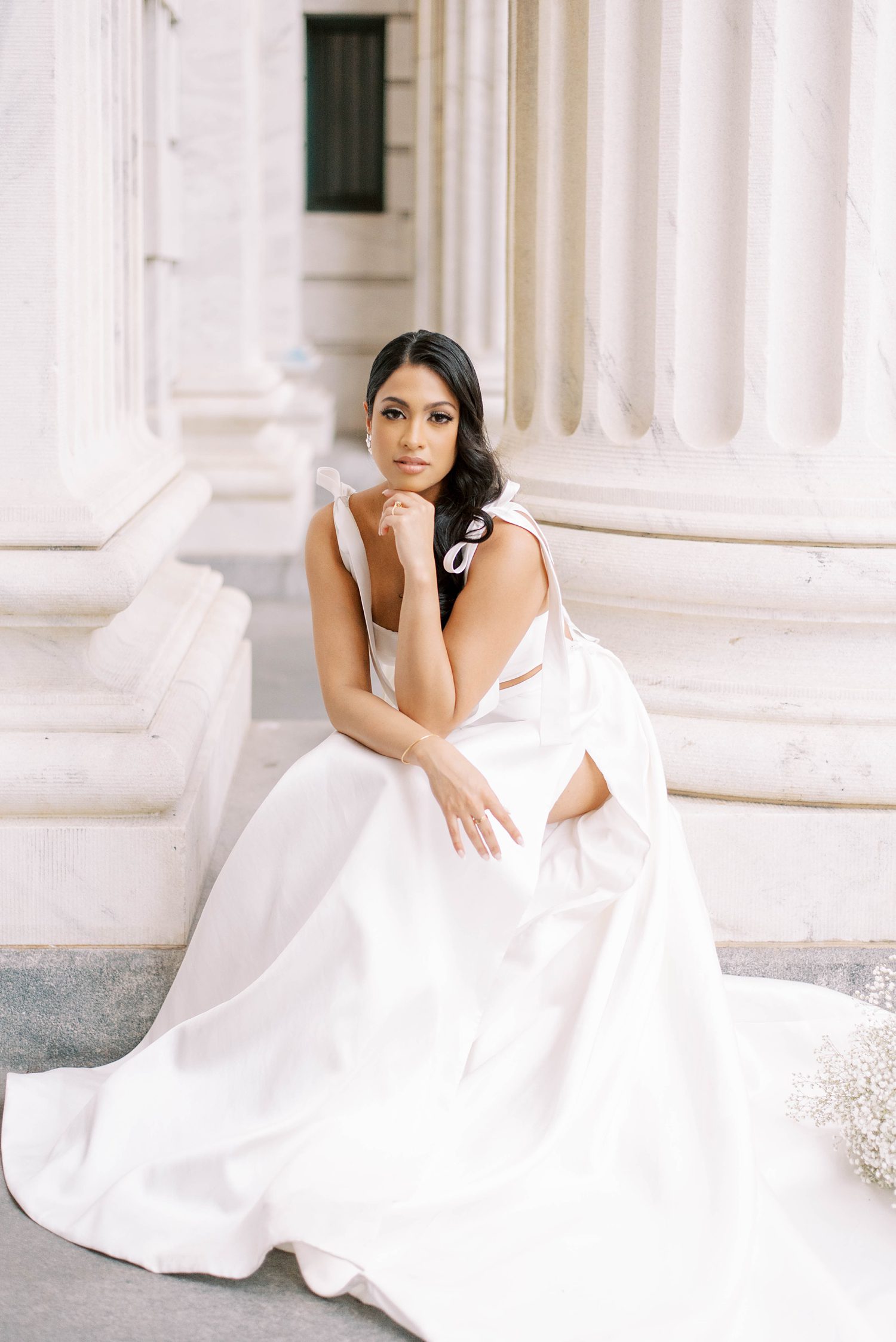 bride sits on steps in Tampa FL in Delana Muse gown