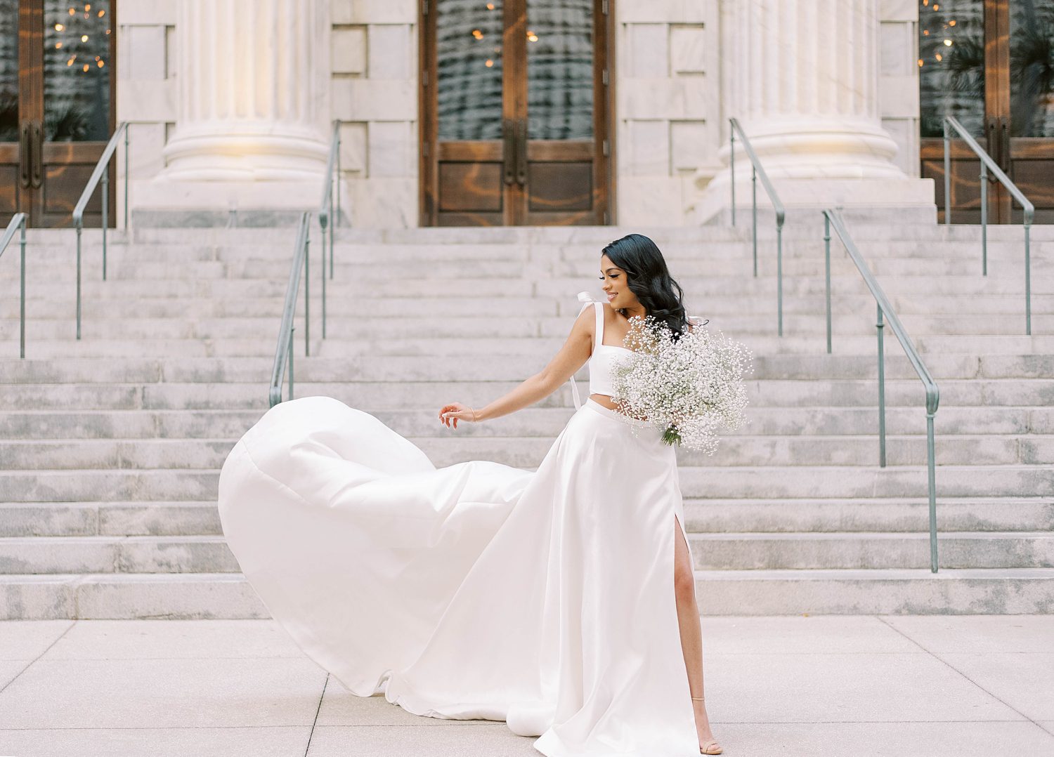 bride tosses skirt of Delana Muse gown on Tampa courthouse steps