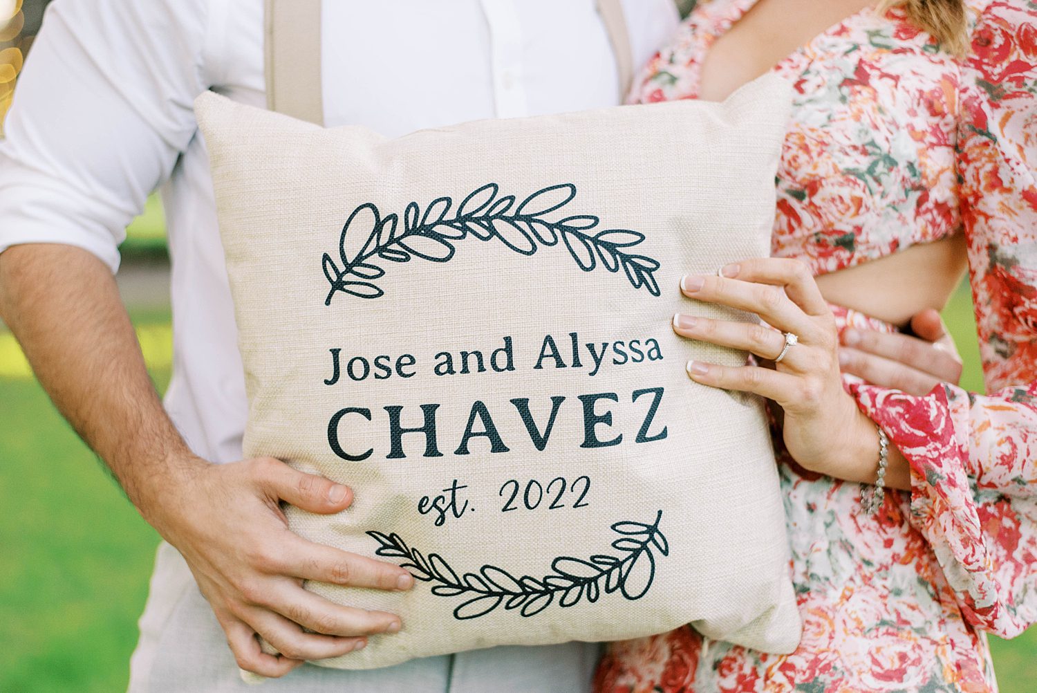 couple holds custom pillow with wedding date