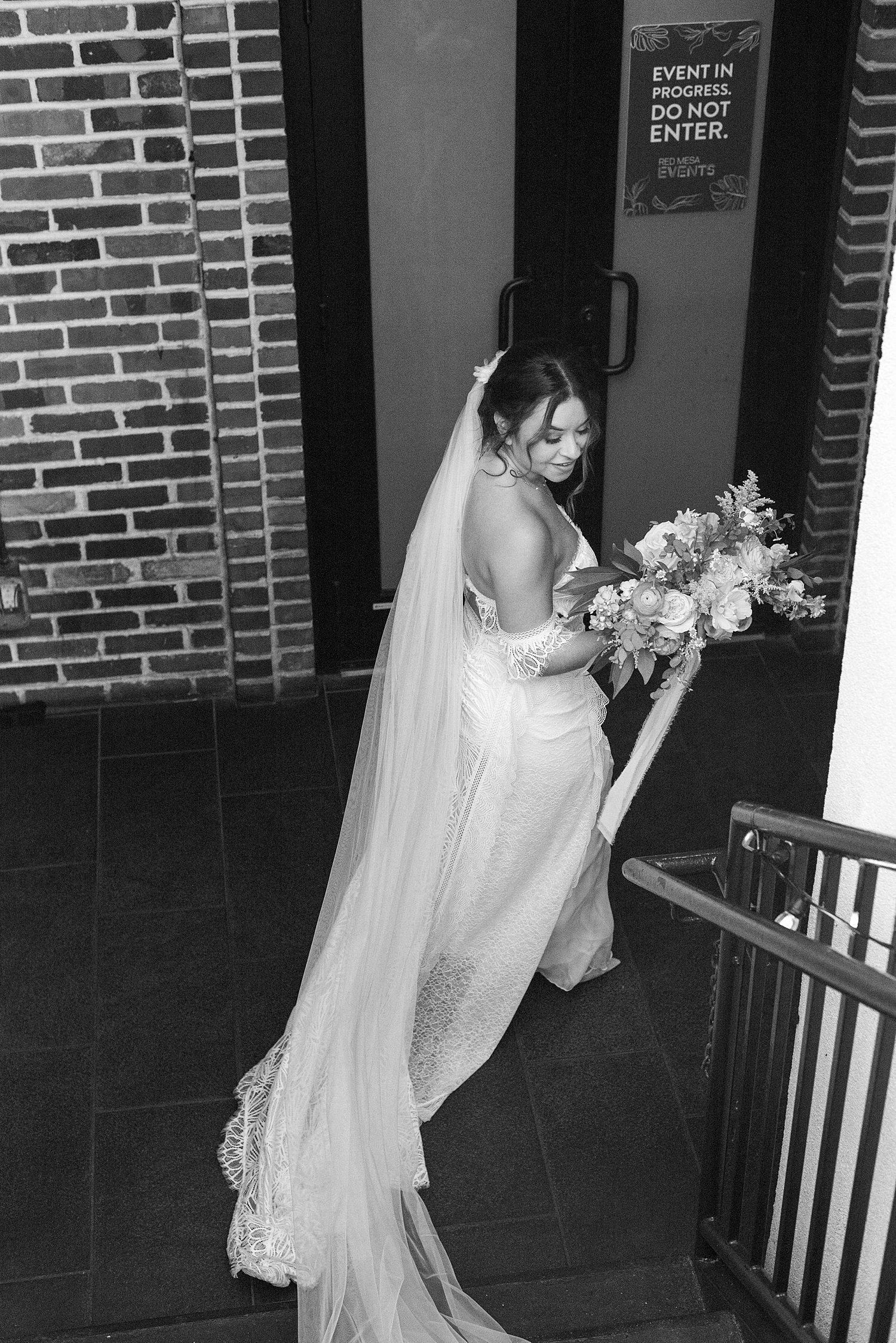 bride walks down steps during Red Mesa Cantina wedding