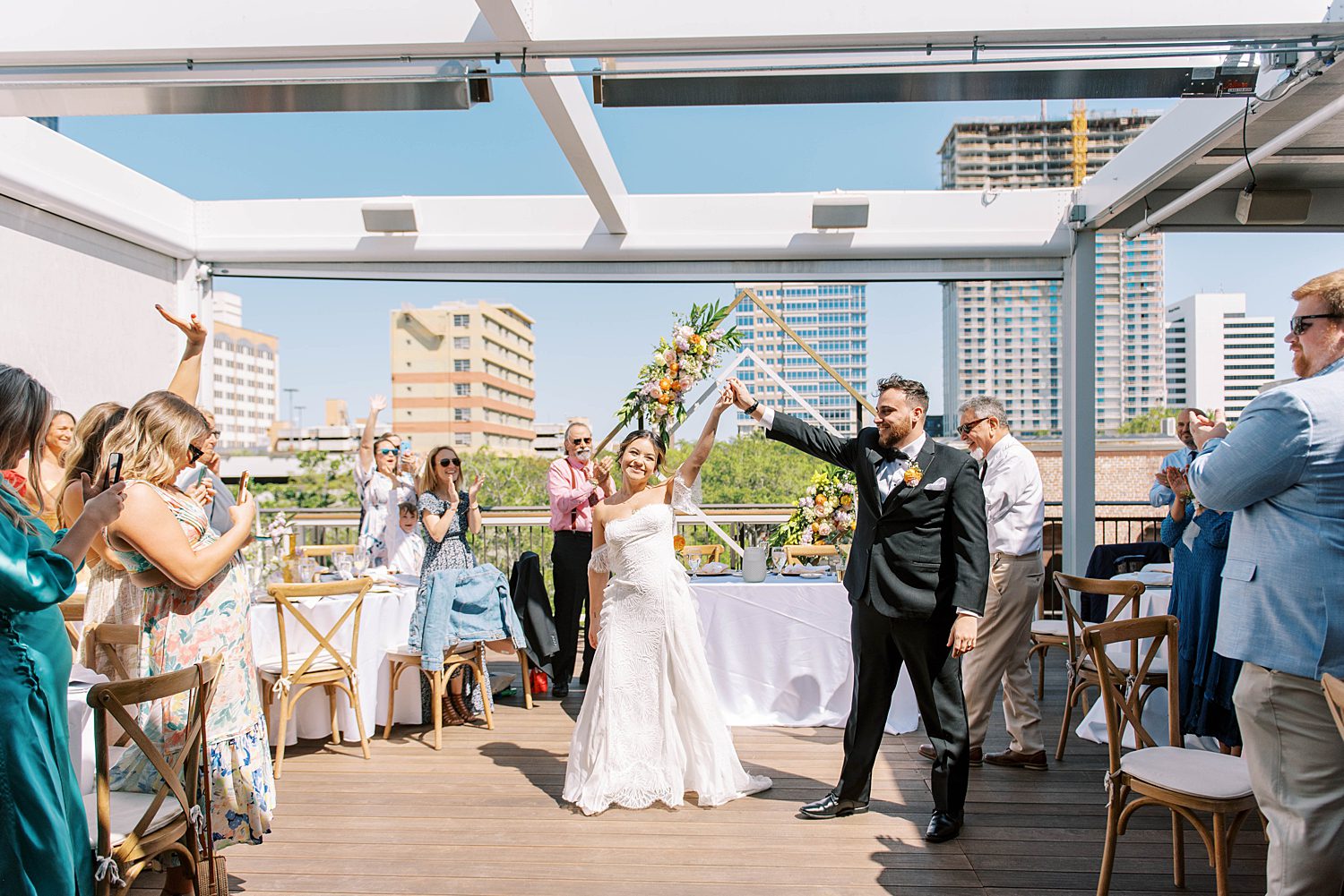 bride and groom enter wedding reception on rooftop at Red Mesa Cantina