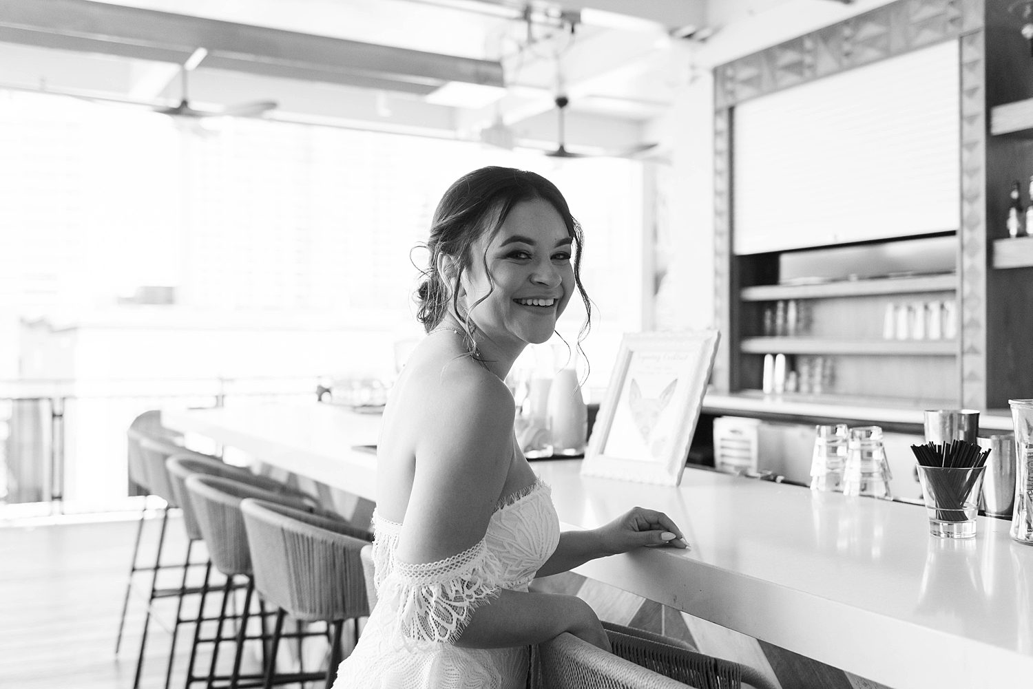 bride smiles at bar during wedding photos at Red Mesa Cantina