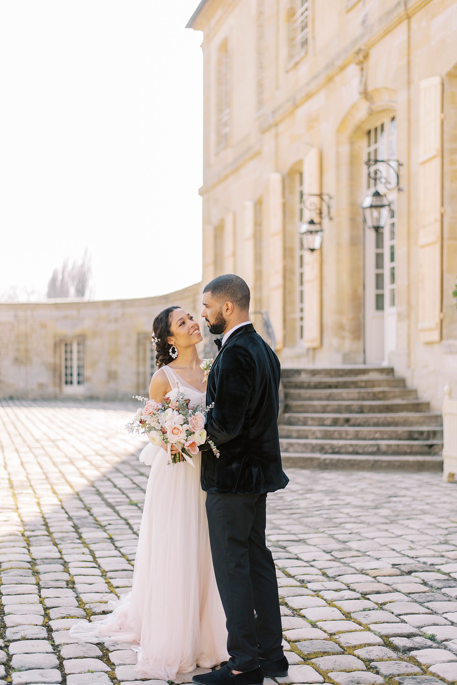 bride smiles at groom during wedding portraits in Paris 