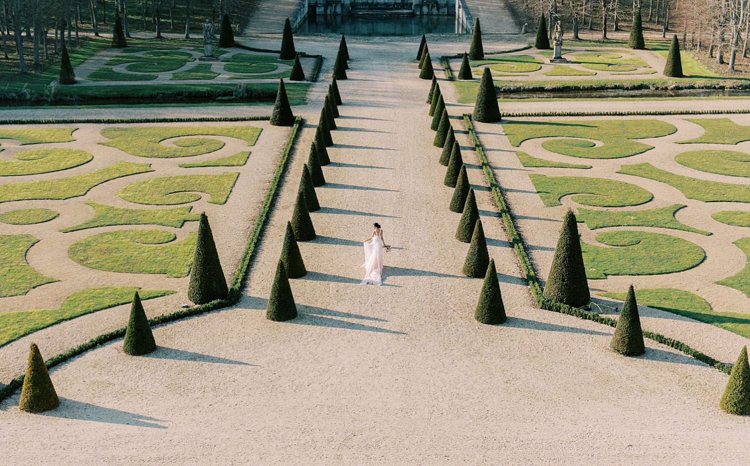 bride walks through garden of Chateau de Villette