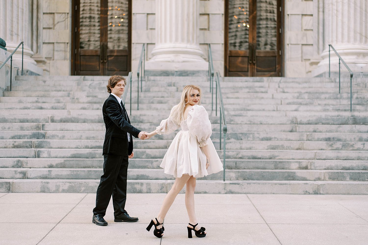 engaged couple walks by city hall during downtown Tampa engagement session