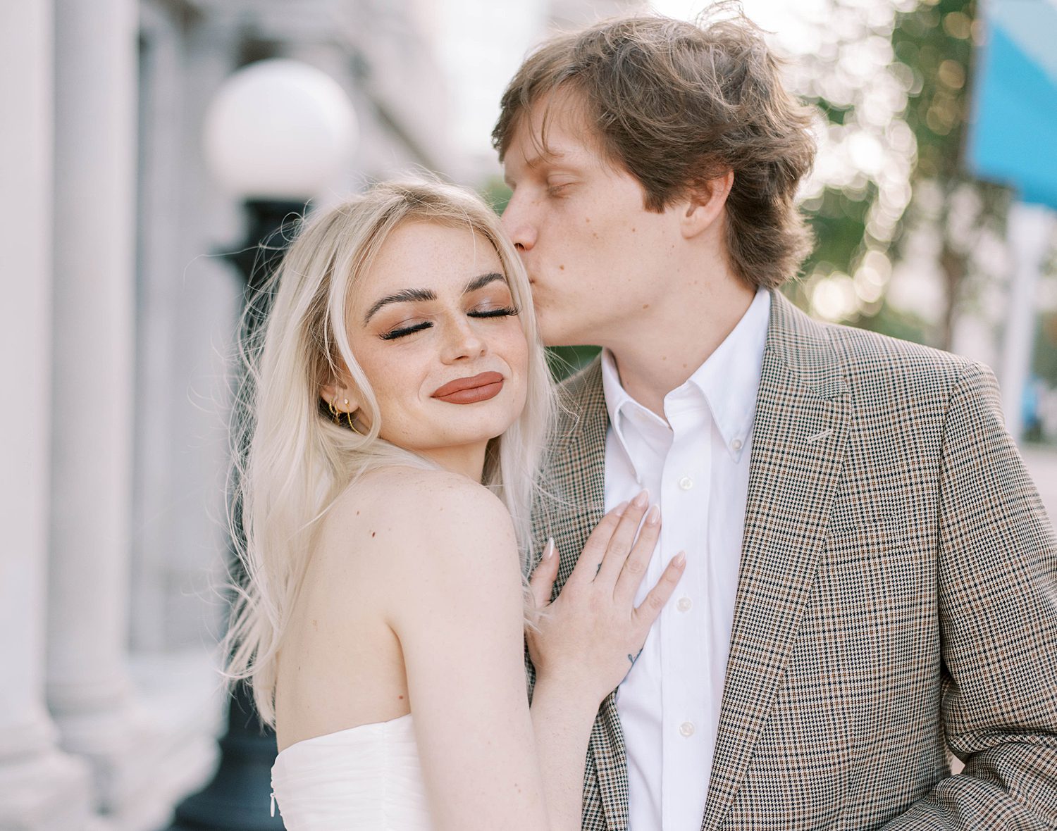 man kisses fiancee's forehead during FL engagement photos 