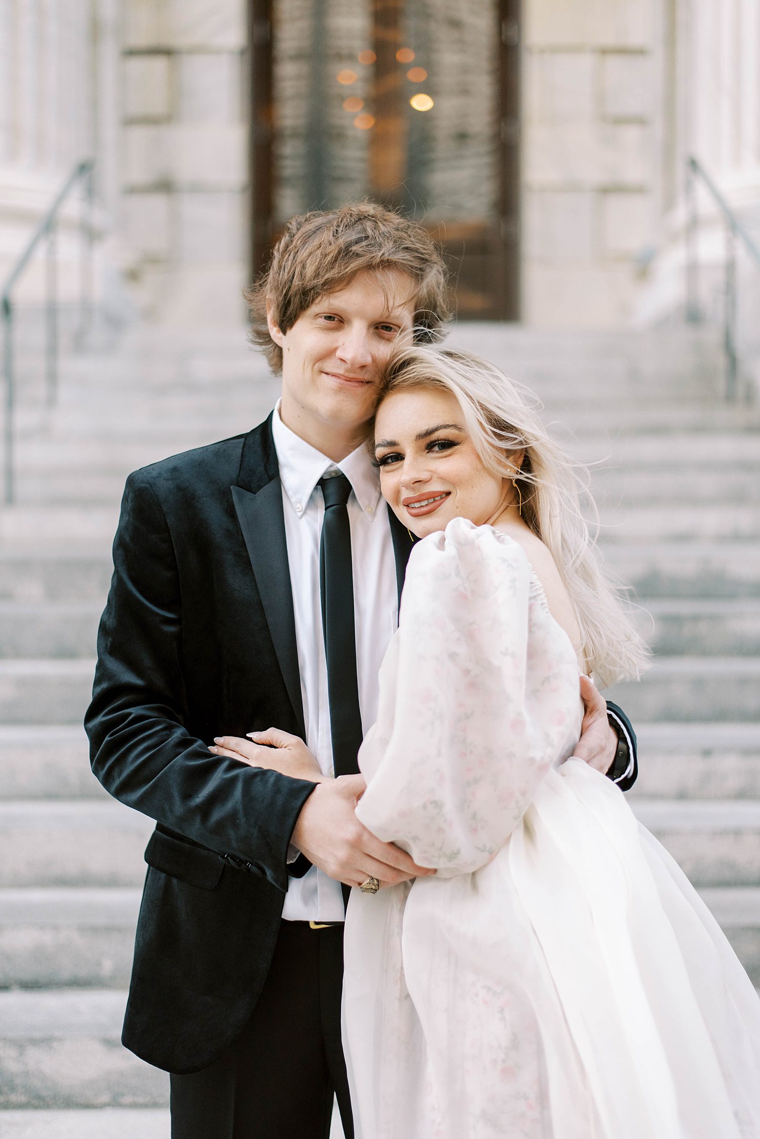 woman leans against man's chest during downtown Tampa engagement session