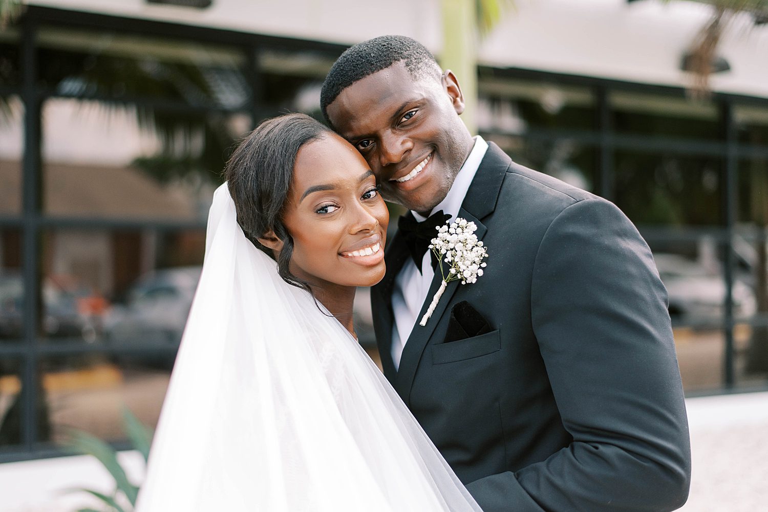 newlyweds hug outside Haus 820 during portraits in Central Florida