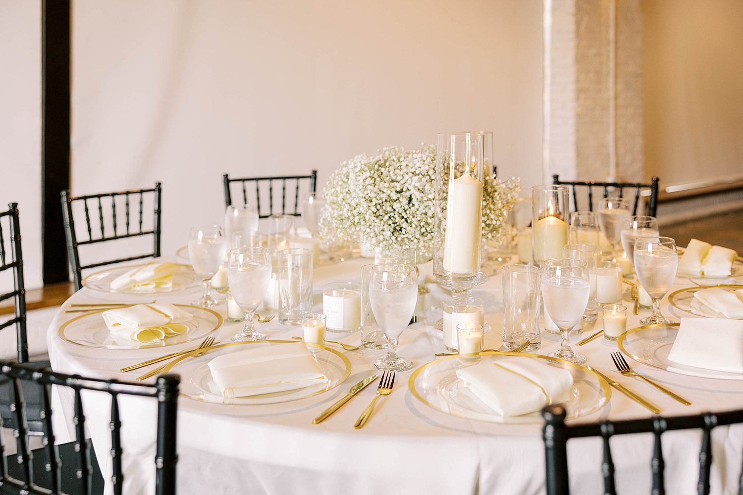 gold rimmed plates and pillar candles by baby's breath for Haus 820 wedding