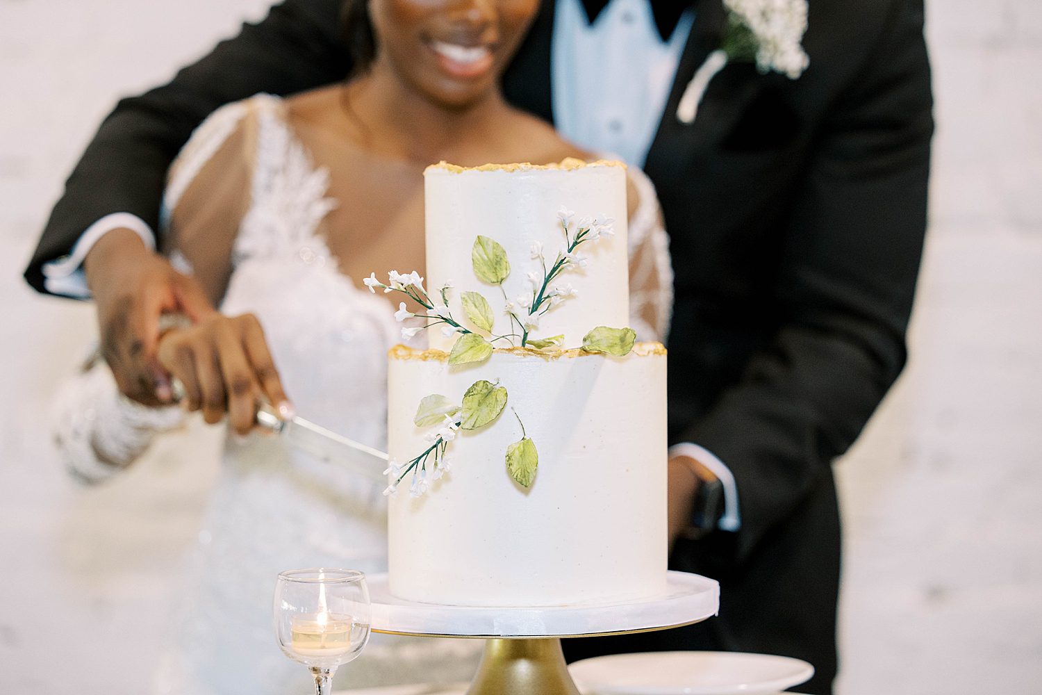 bride and groom cut wedding cake during FL wedding reception