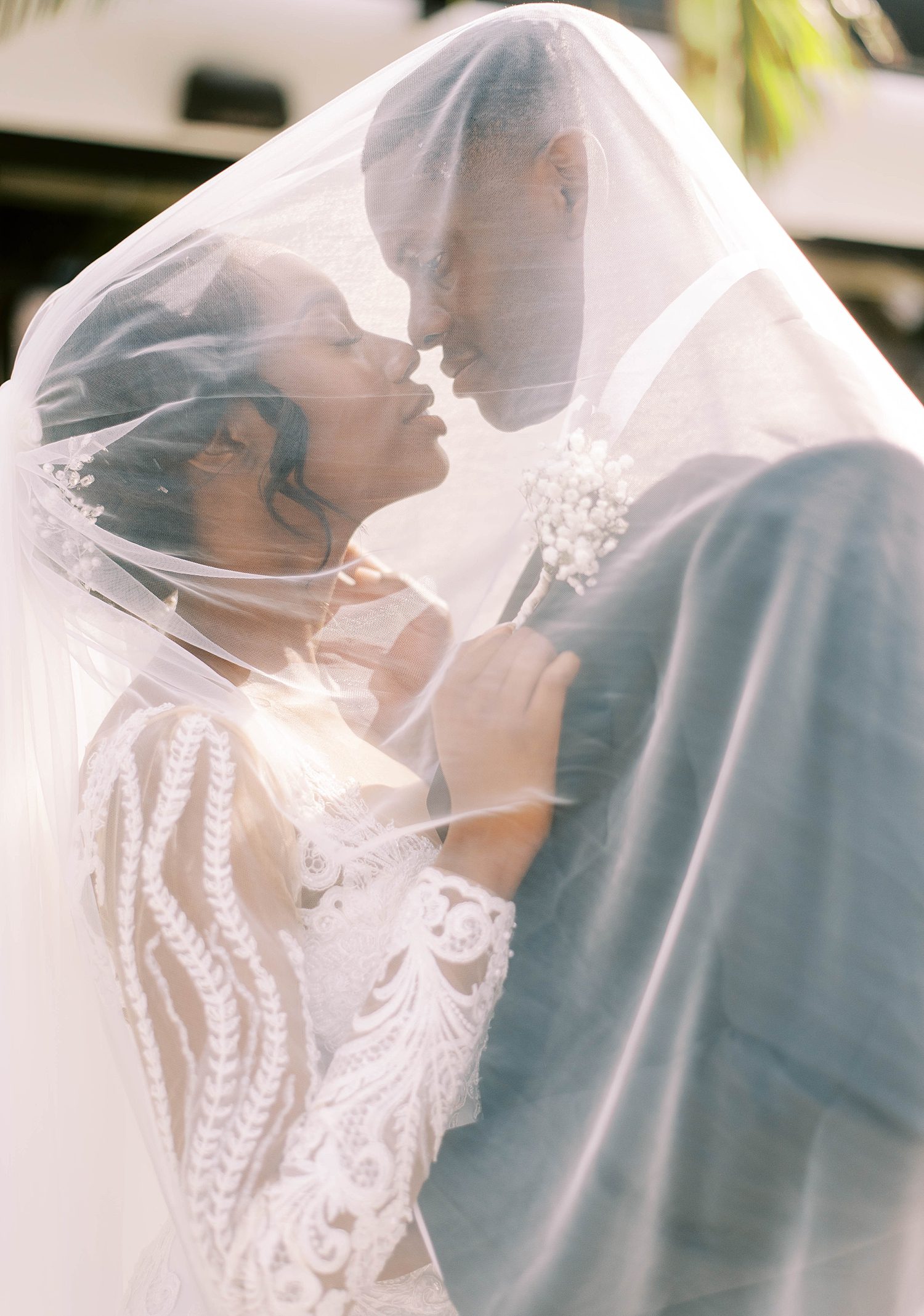bride and groom lean together under bride's veil at Haus 820