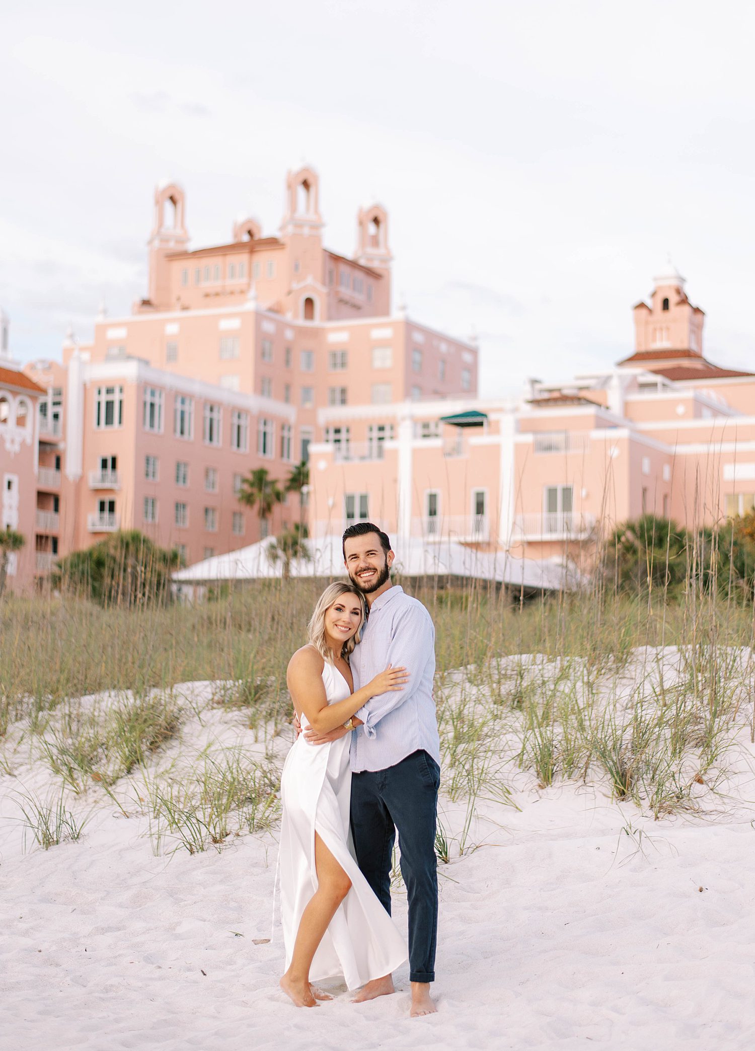 engaged couple stands in front of Don Cesar Hotel in St. Pete FL