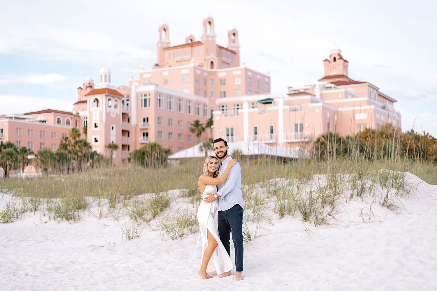 couple hugs on the beach by the Don Cesar hotel