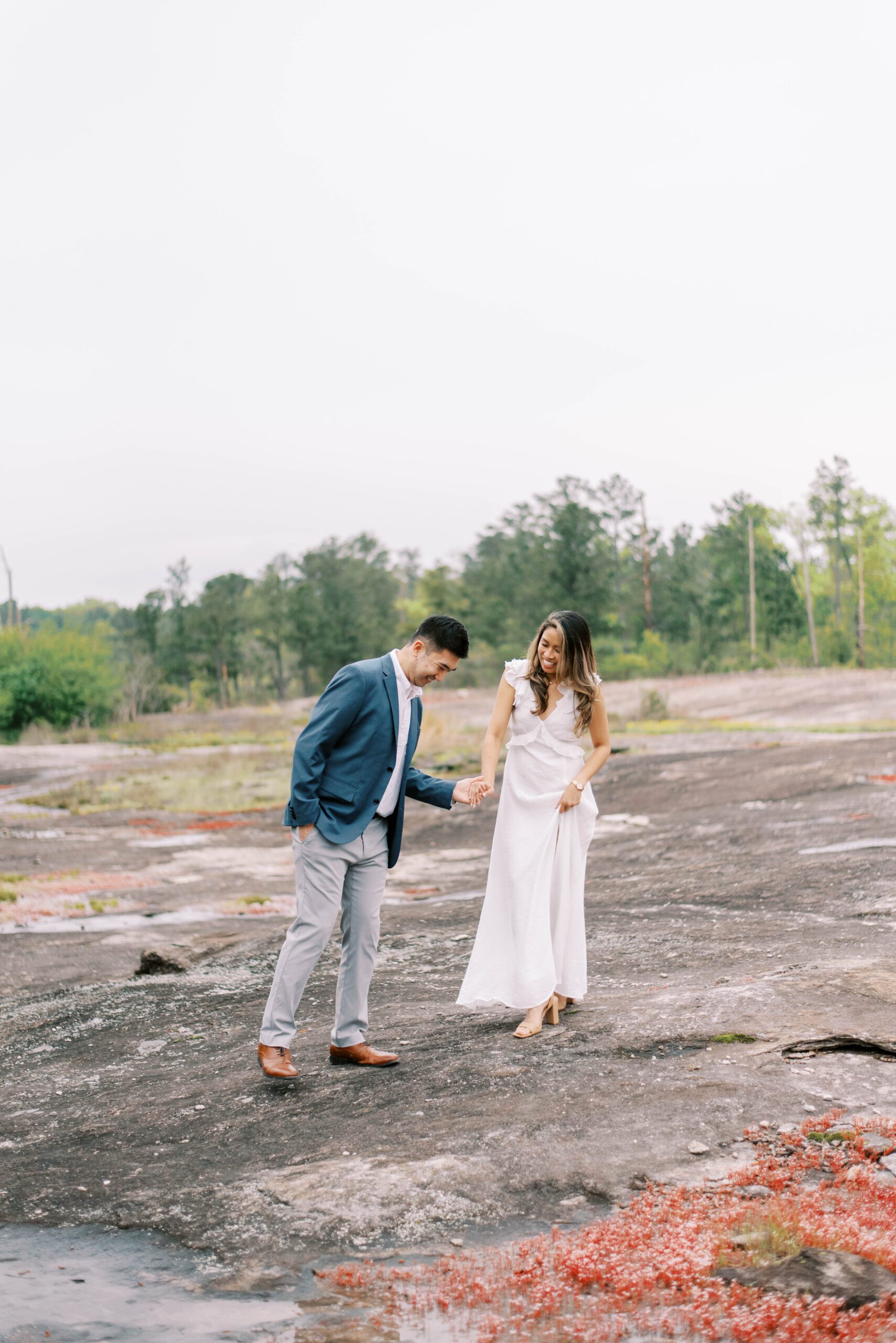 engaged couple hugs on mountaintop in Atlanta GA