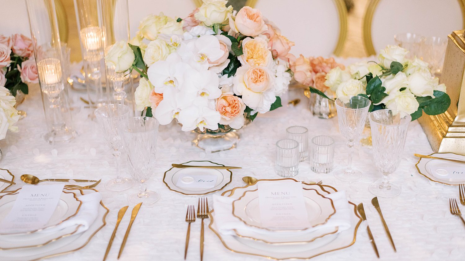 glamorous wedding reception place settings with gold and white