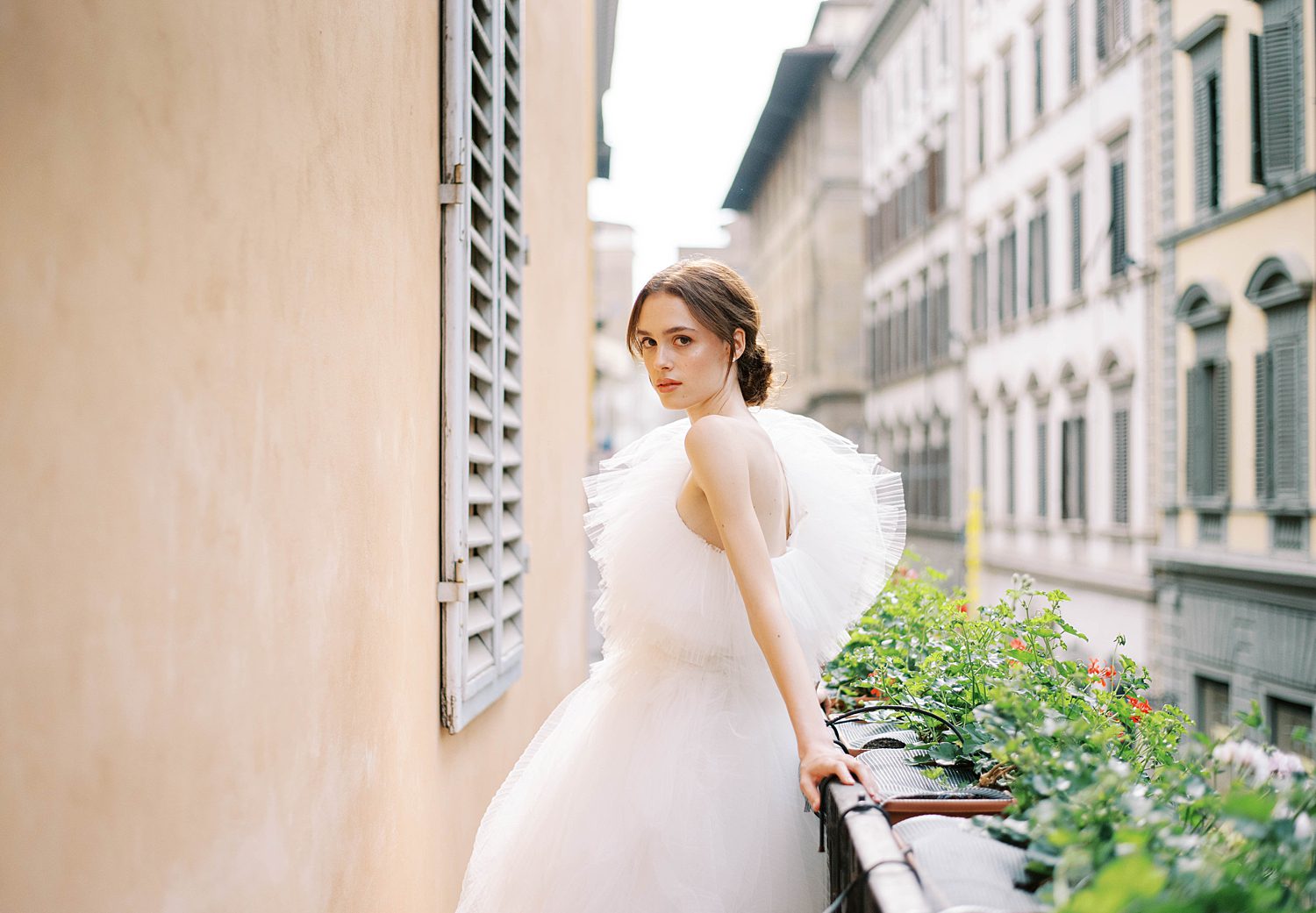bride leans on balcony in Florence hotel