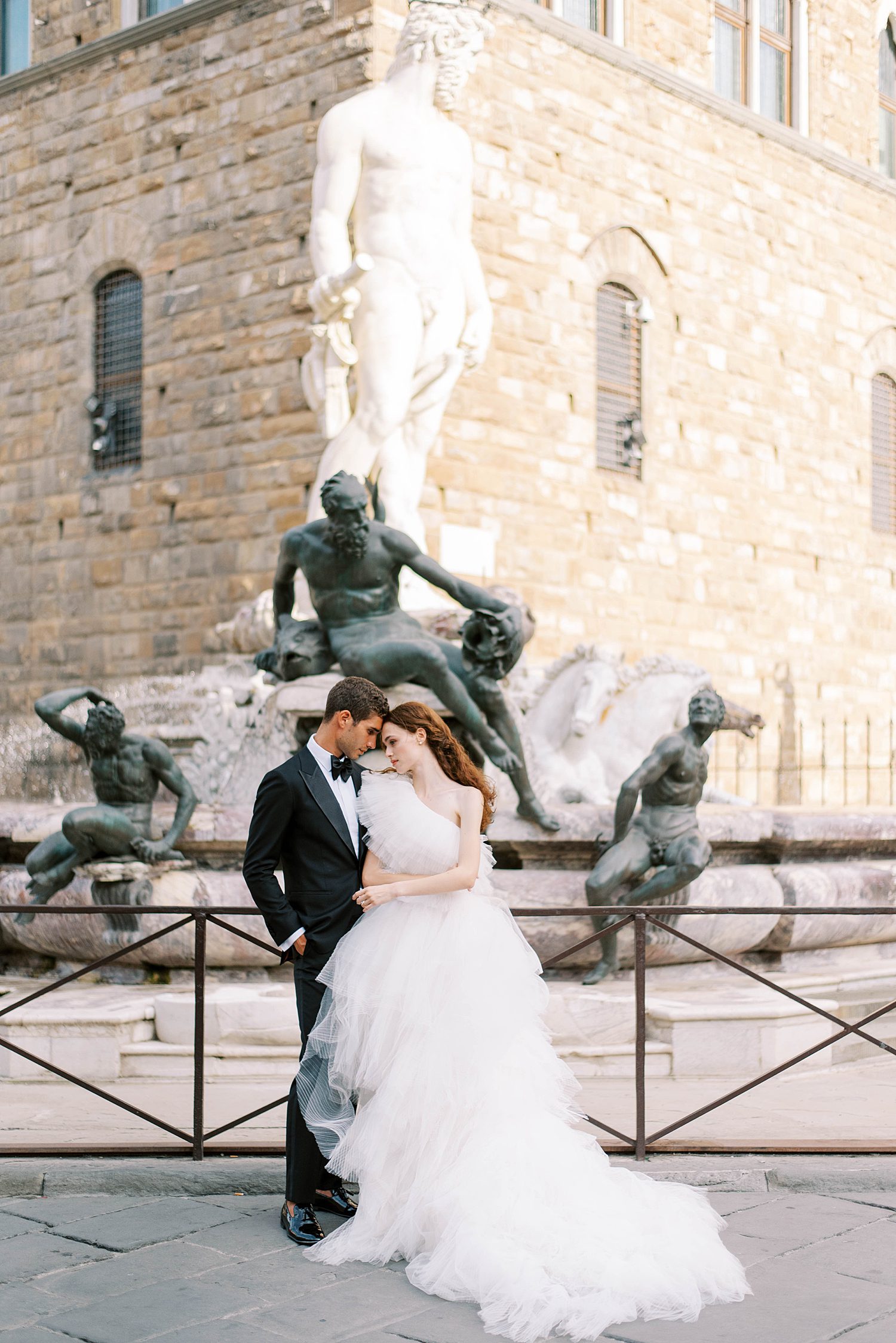 Florence Italy wedding photographer photographs couple by classic statue 