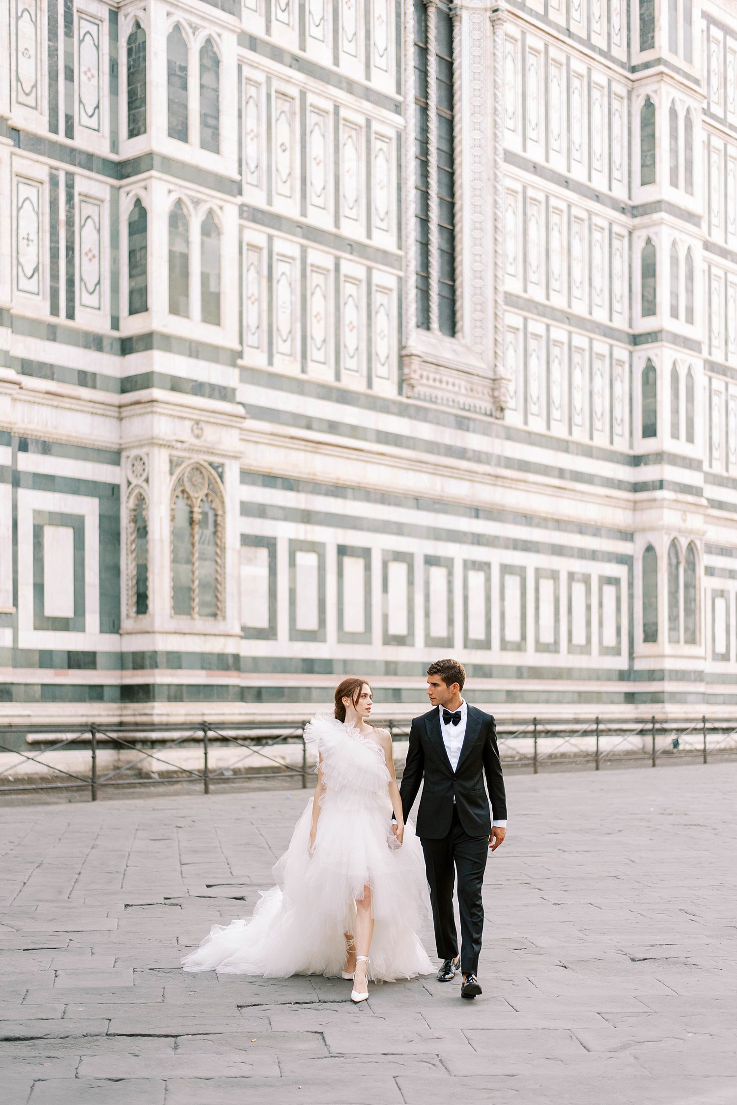 bride and groom hold hands walking in Florence Italy