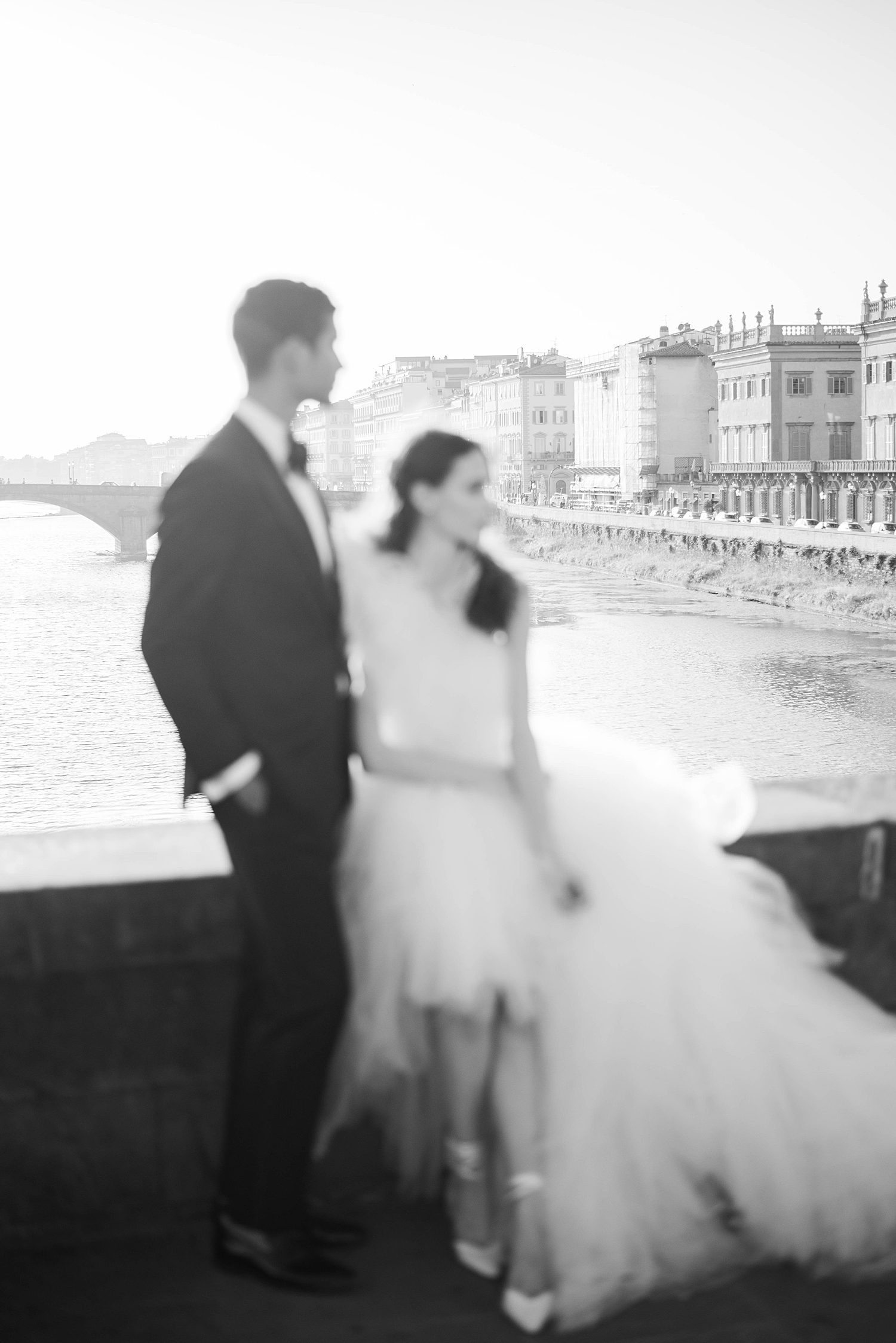 blurry black and white portrait of newlyweds on bridge in Florence Italy 