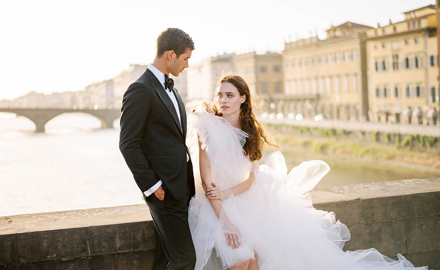 bride looks at groom in classic tux in Florence Italy