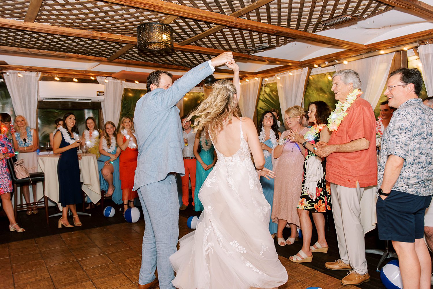 groom twirls bride during Cafe Gabbiano wedding reception