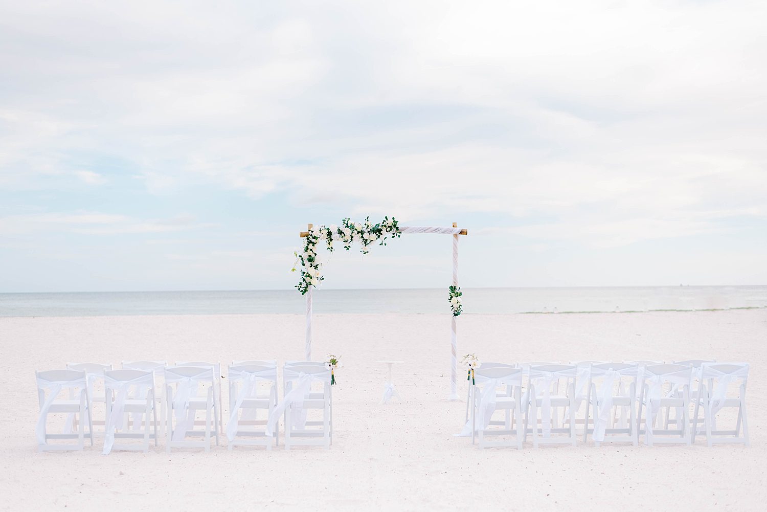 ceremony arbor with florals at Lido Key Beach