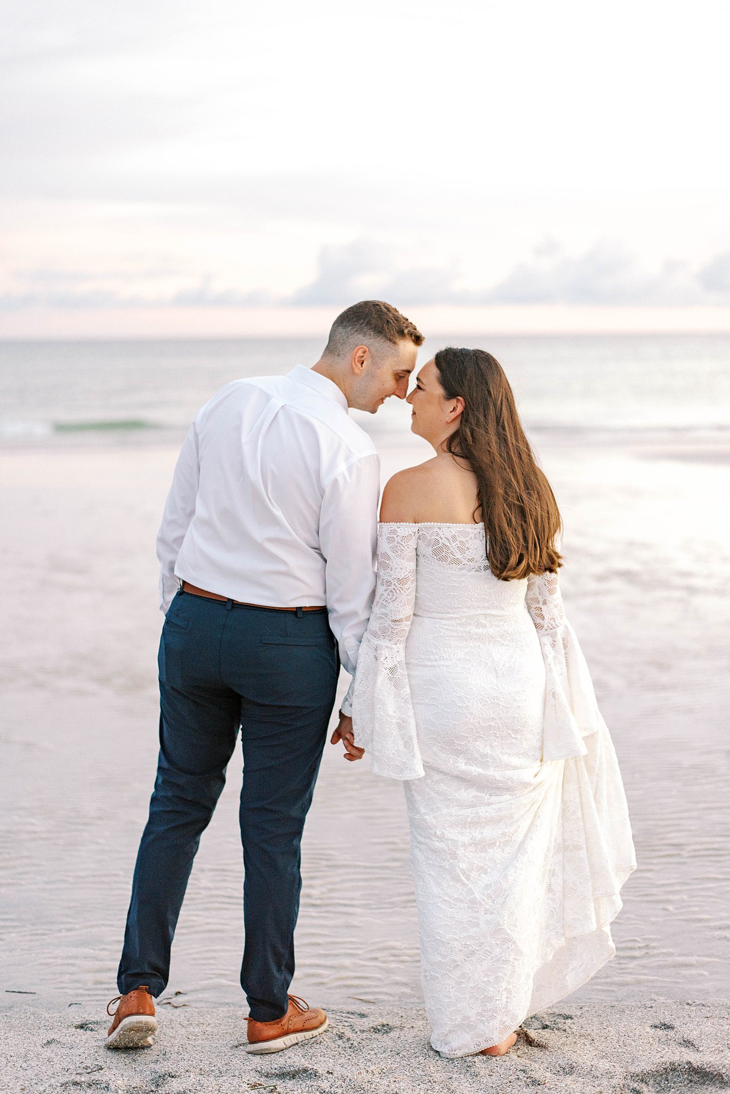 bride and groom kiss during Lido Key Beach wedding day